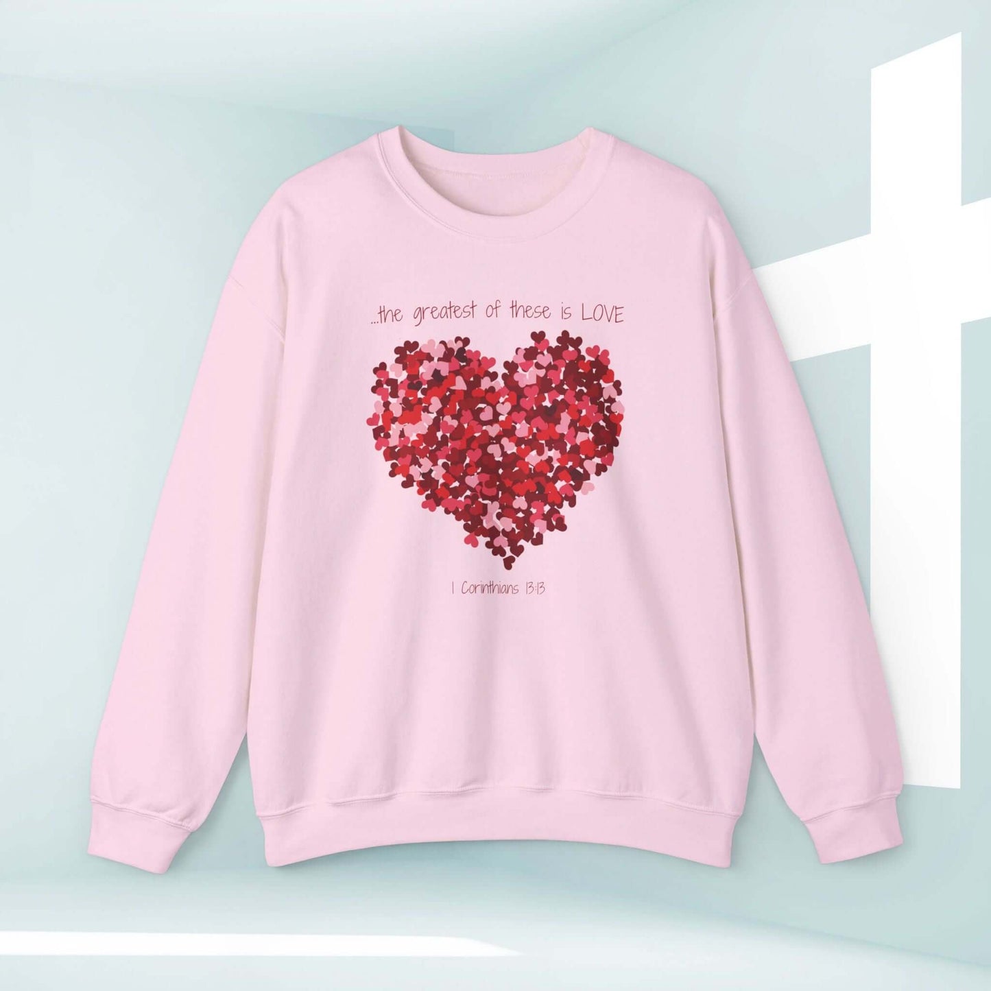 Pink Christian love sweatshirt with heart design and "The greatest of these is LOVE" Bible verse, perfect for valentines or wedding gift.