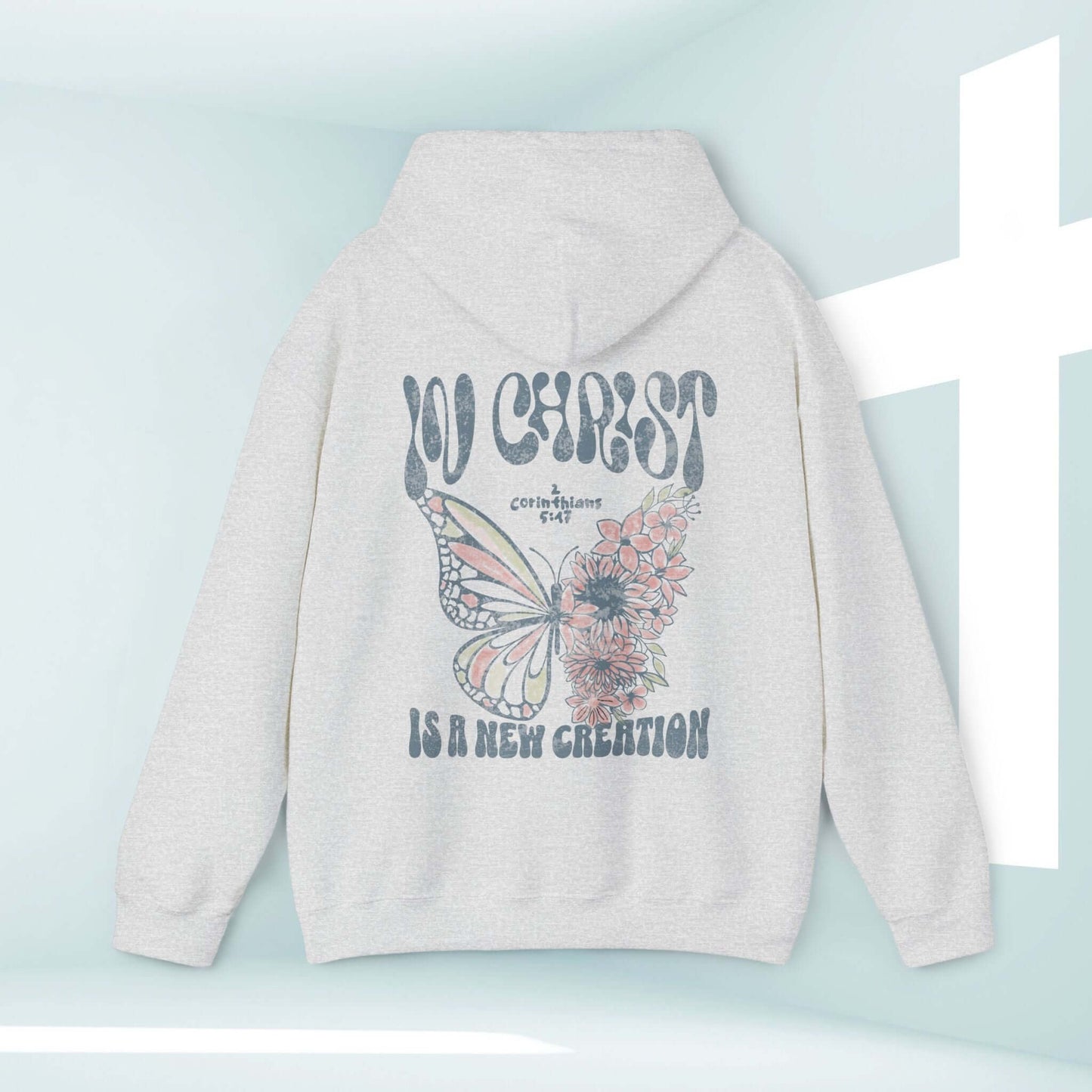 Butterfly Christian hoodie with "In Christ Is A New Creation" Bible verse, faith-based design by Thankfully Christian.