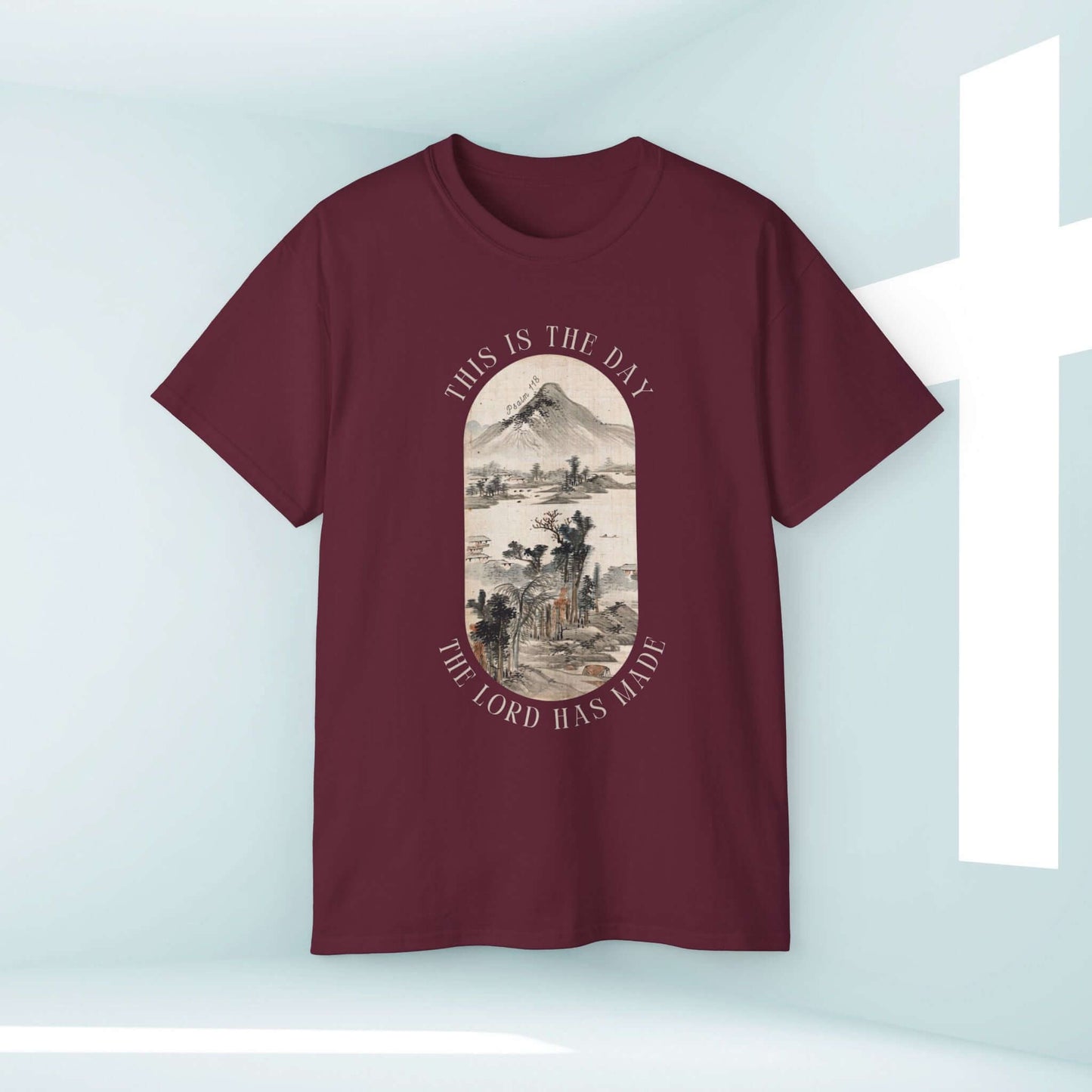 This Is The Day The Lord Has Made men's Christian t-shirt with mountain nature design on maroon fabric, perfect for outdoors and camping.