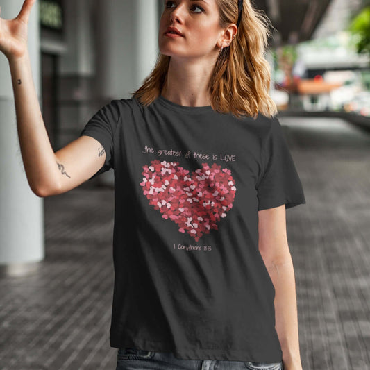 Woman wearing a Christian Valentines Day T-Shirt with heart design reading "The greatest of these is LOVE" for wedding or anniversary gift.