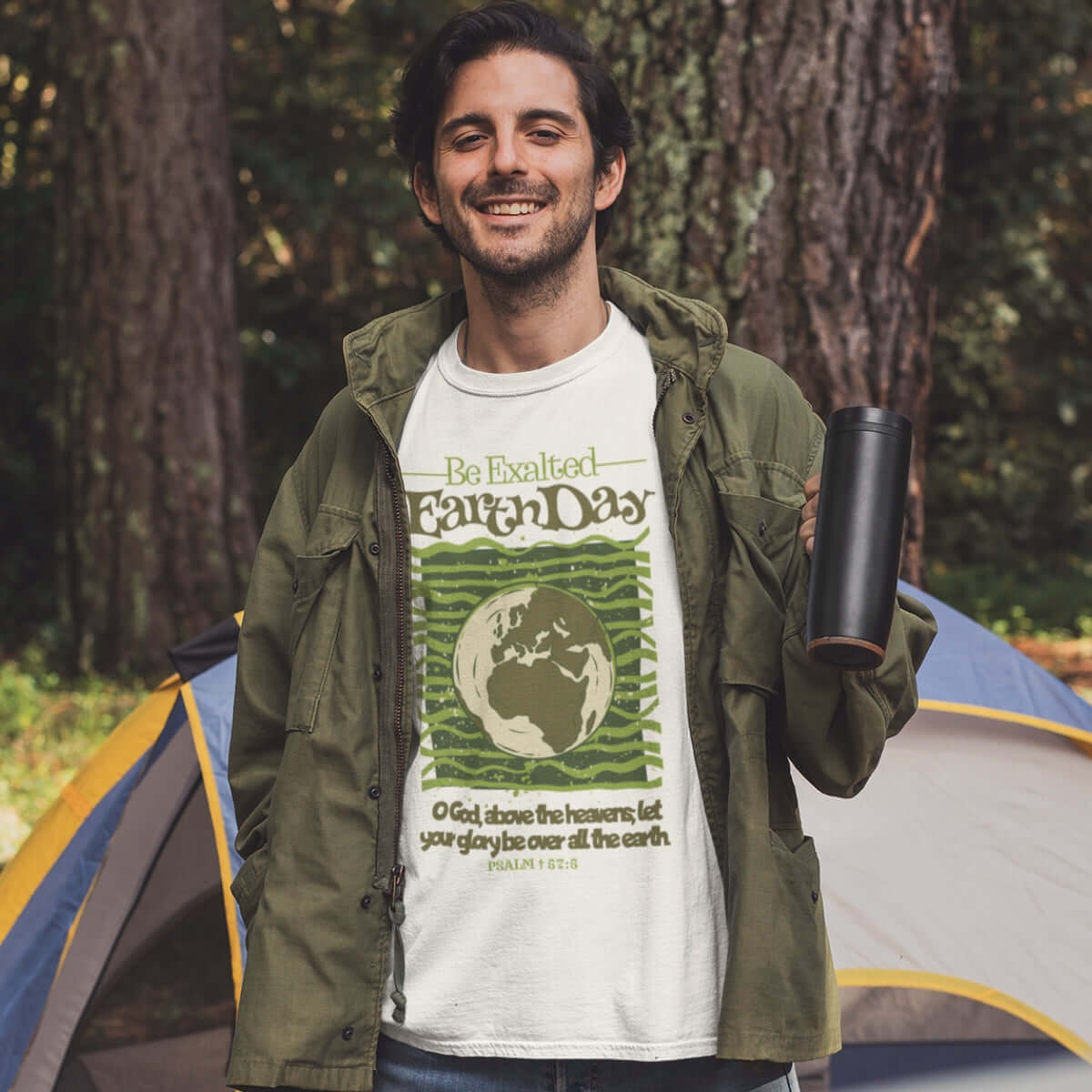 Man wearing Earth Day Be Exalted Christian T-Shirt camping in nature, showcasing Christian apparel and faith-based shirt with scripture.