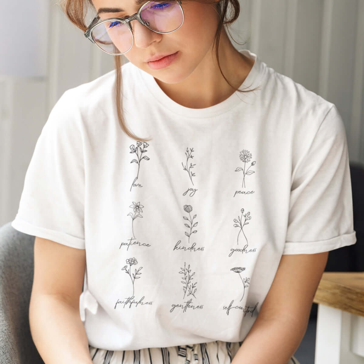 Woman wearing Fruits of the Spirit shirt, white Christian tee shirt with inspirational bible verse design.