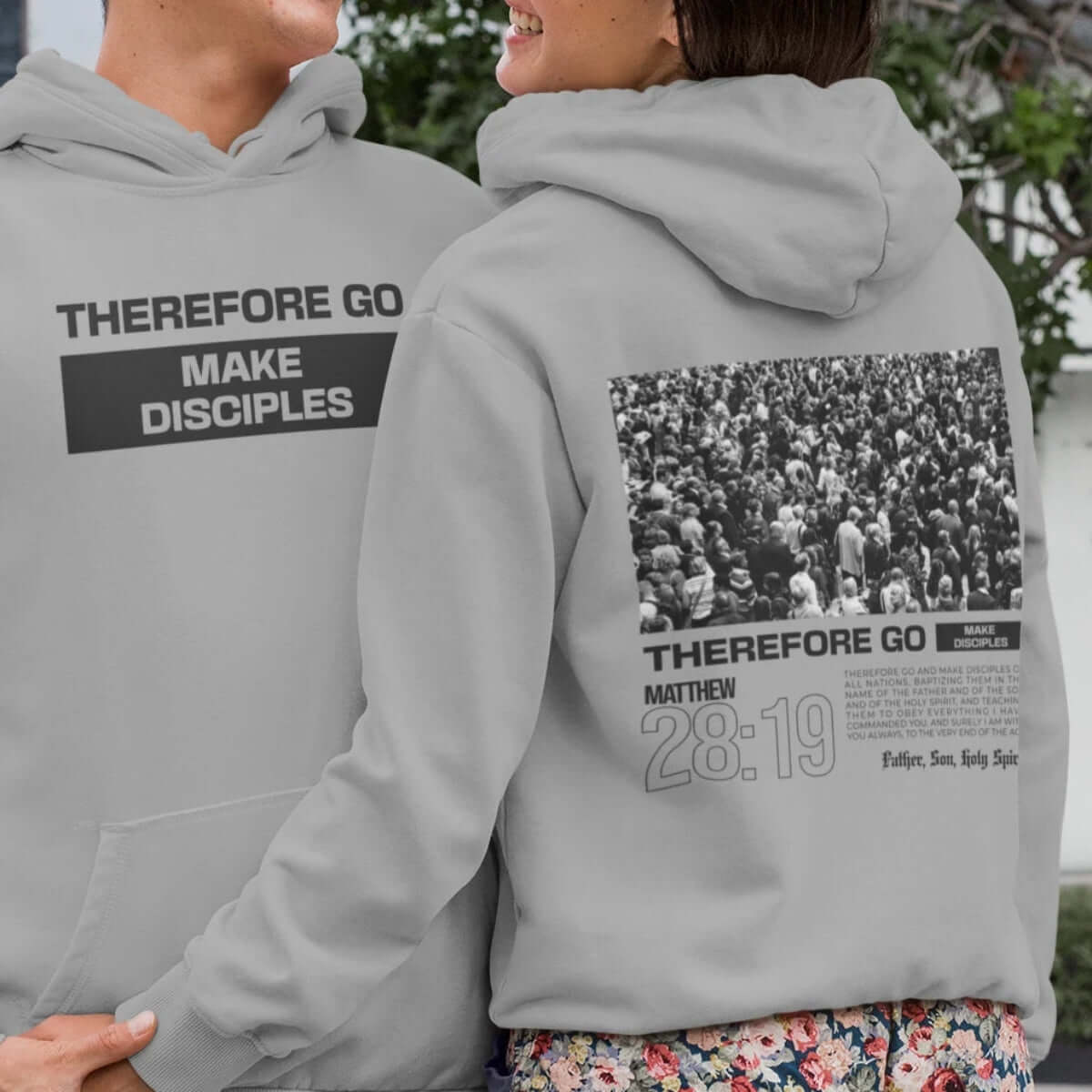 Two people wearing gray Christian hoodies with "Therefore Go Make Disciples" Bible verse design, spreading faith and inspiration.