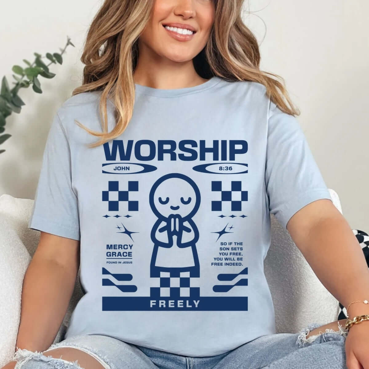 Woman wearing a Christian worship shirt with a prayer graphic and Bible verse, promoting faith and religious devotion.