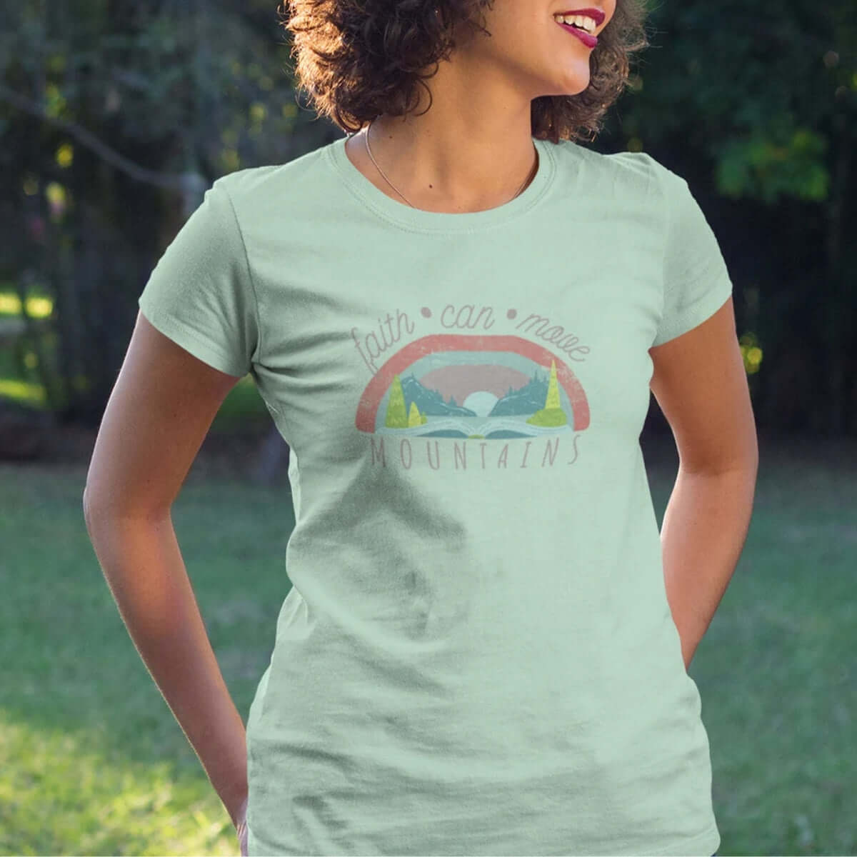 Woman wearing Faith Can Move Mountains Christian t-shirt outdoors, Christian apparel.