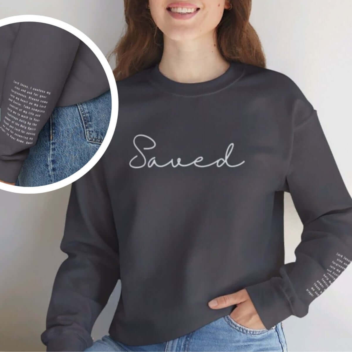 Woman wearing a Christian sweatshirt with "Saved" on front and Sinners Prayer on sleeve, faith-based religious crewneck sweater.