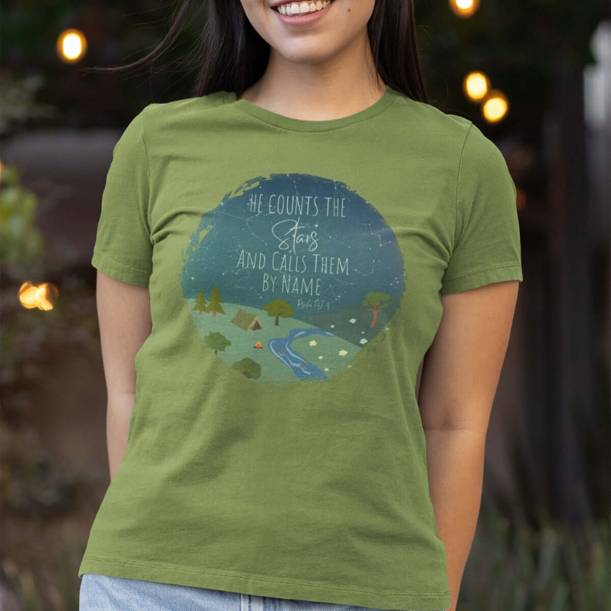 Woman wearing green He Counts The Stars And Calls Them By Name Christian t-shirt with nature graphic, inspirational faith-based apparel.