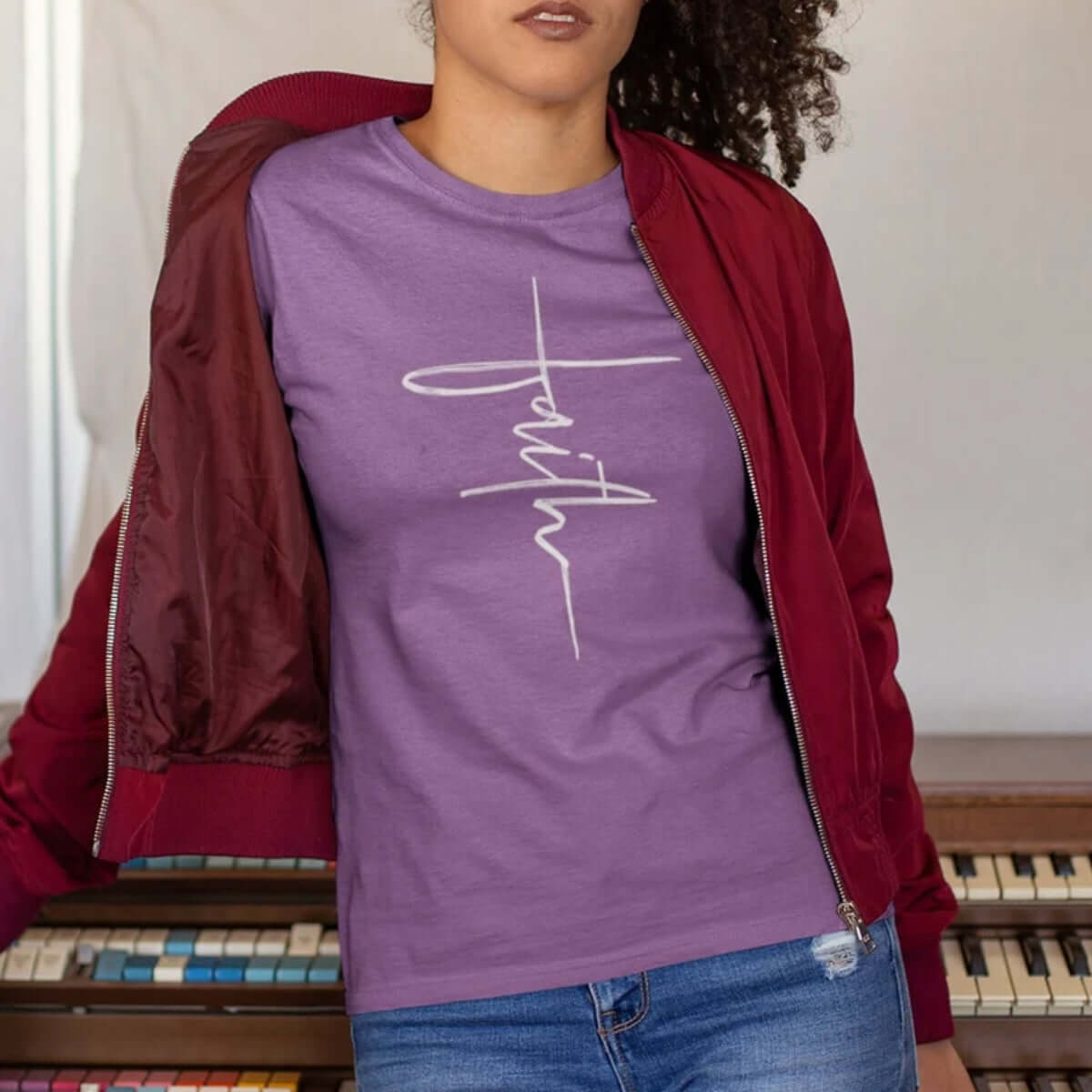 Woman wearing purple "Faith" cross Christian T-shirt, inspirational Bible verse clothing, faith shirt for women, Christian gift idea.