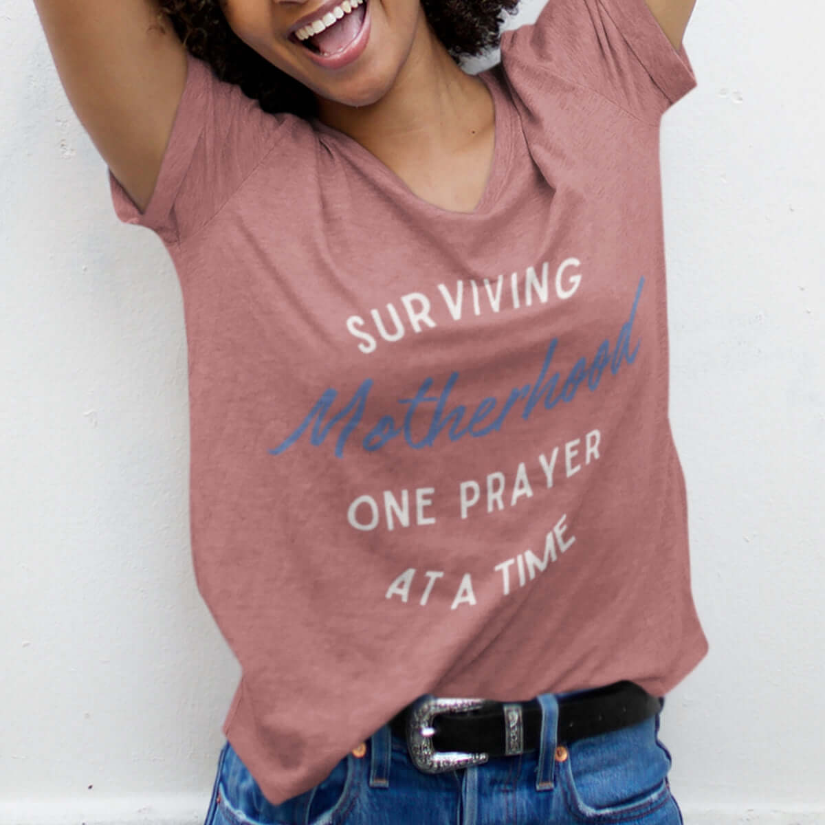 Woman wearing "Surviving Motherhood One Prayer At A Time" Christian tee; faith-based inspirational shirt for moms