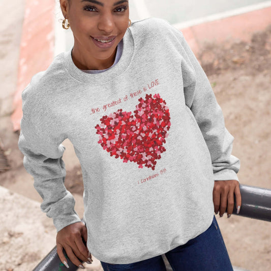 Woman wearing greatest love wedding anniversary valentines sweatshirt with heart graphic - Christian apparel Valentines day gift