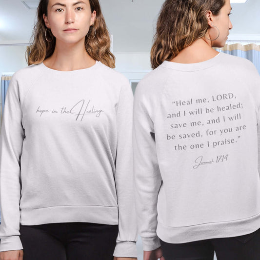 Woman wearing Hope In The Healing Christian sweatshirt with Bible verse from Jeremiah 17:14 on the back, get well soon gift for cancer survivors