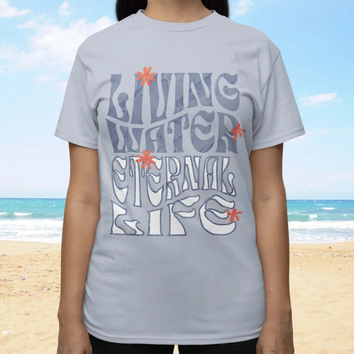 Person wearing Living Water Eternal Life Christian T-shirt on beach; christian streetwear; religious inspirational tee shirt