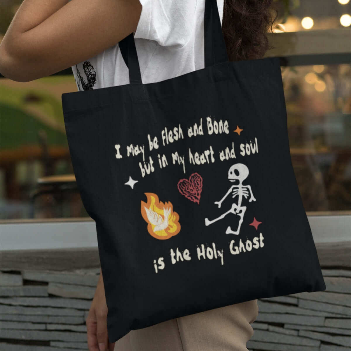 Christian Halloween tote bag with a cute skeleton and inspirational verse, perfect for trick or treat and Halloween faith celebrations.