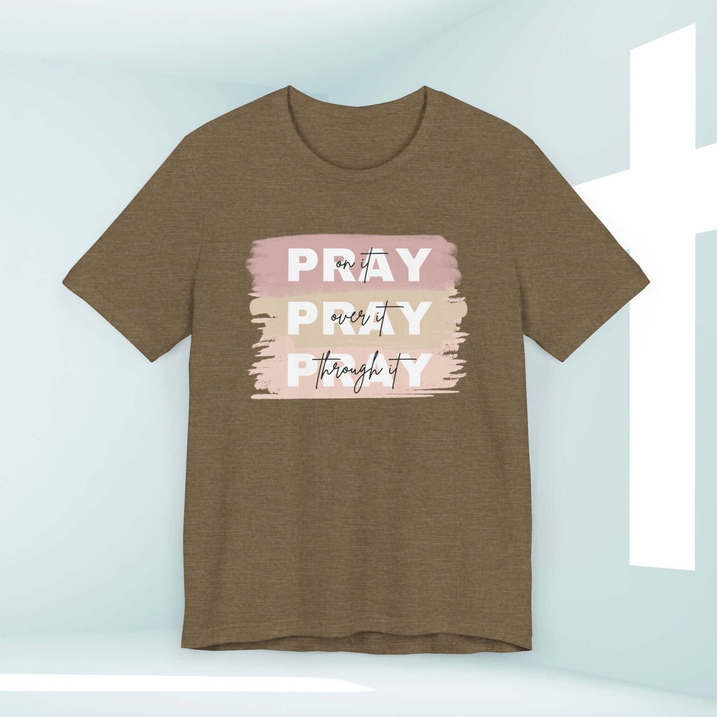 Pray On It, Over It, Through It Christian t-shirt for women with inspirational message in soft colors.