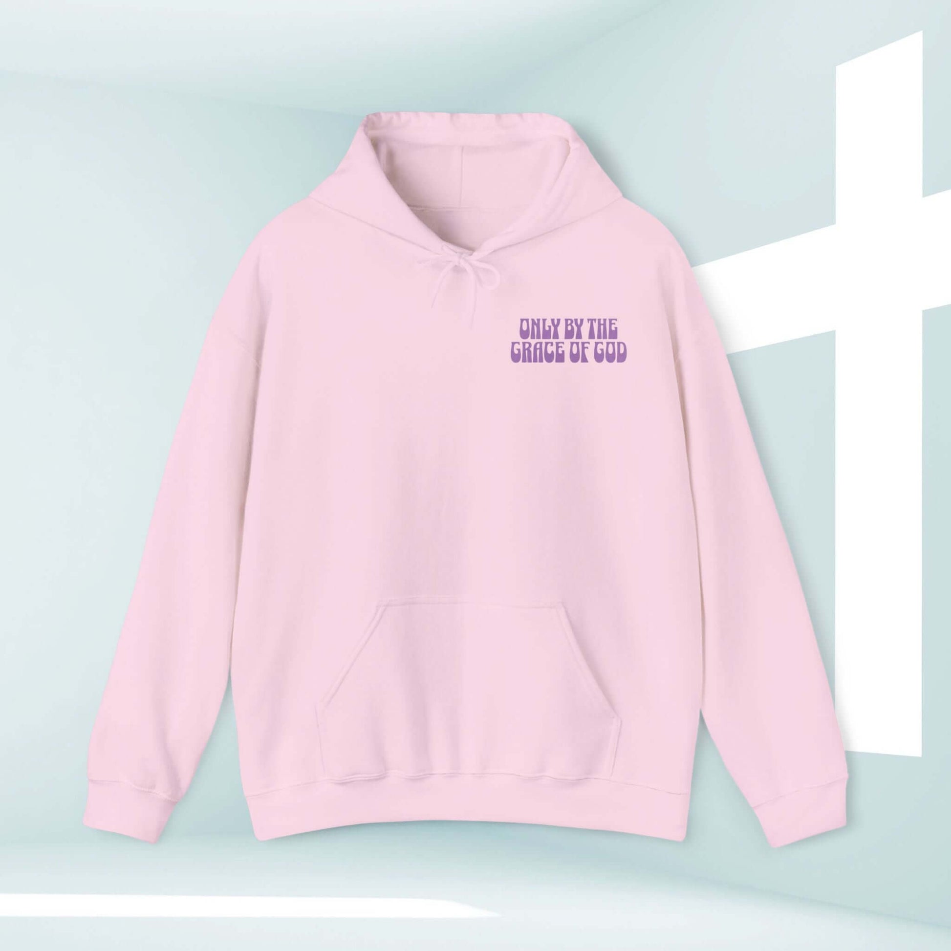 Inspirational pink Christian hoodie with "Only By The Grace Of God" Bible verse, faith-based hooded sweatshirt for religious apparel lovers.