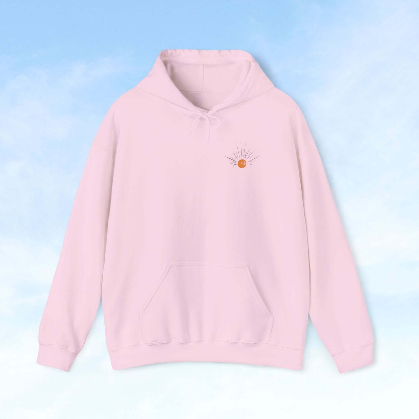 Be The Light Sunburst Christian hoodie with celestial sun ray design on pale pink background, perfect Christian gift and faith-based apparel.