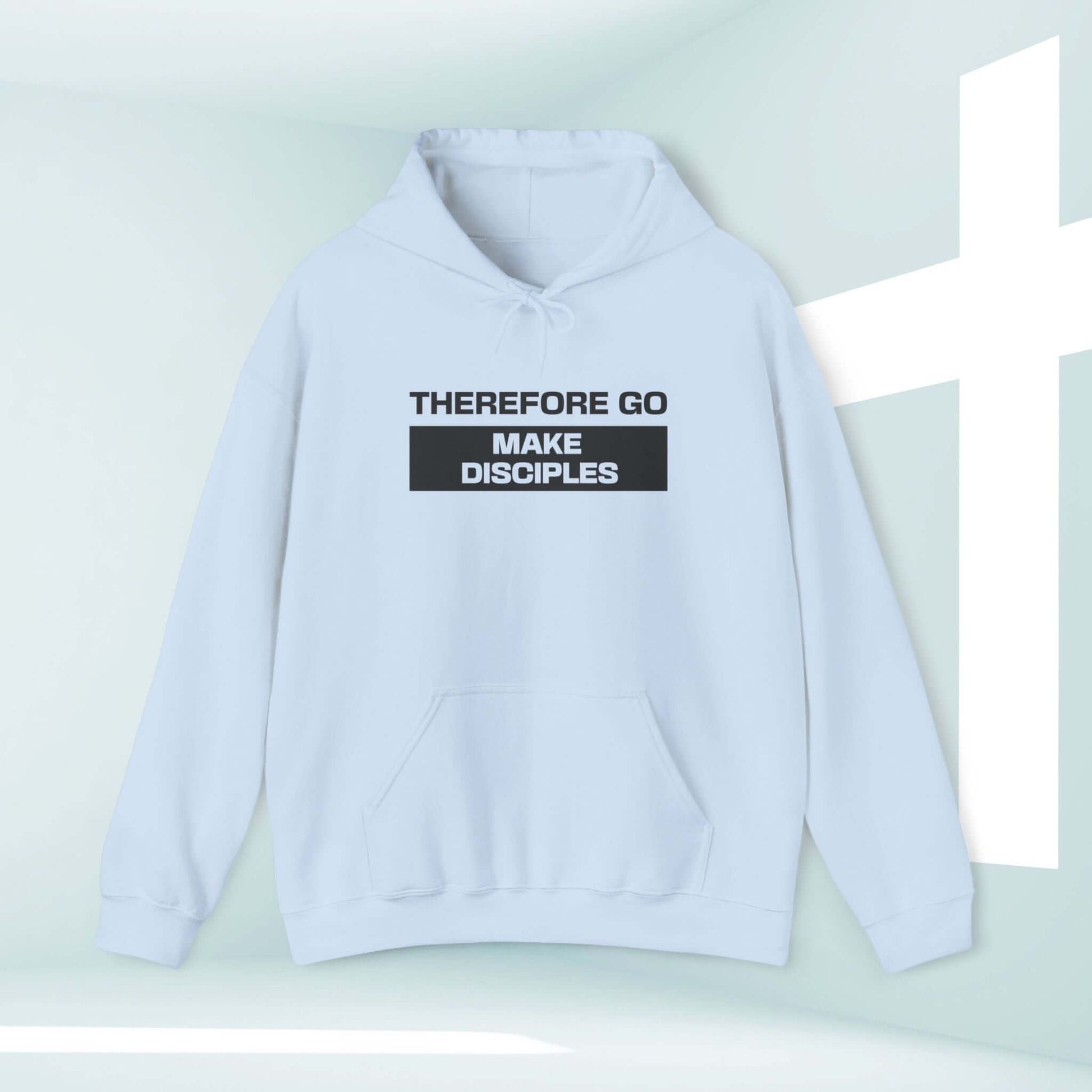 Christian hoodie with "Therefore Go Make Disciples" Bible verse text, light blue hooded sweatshirt with a cross background.