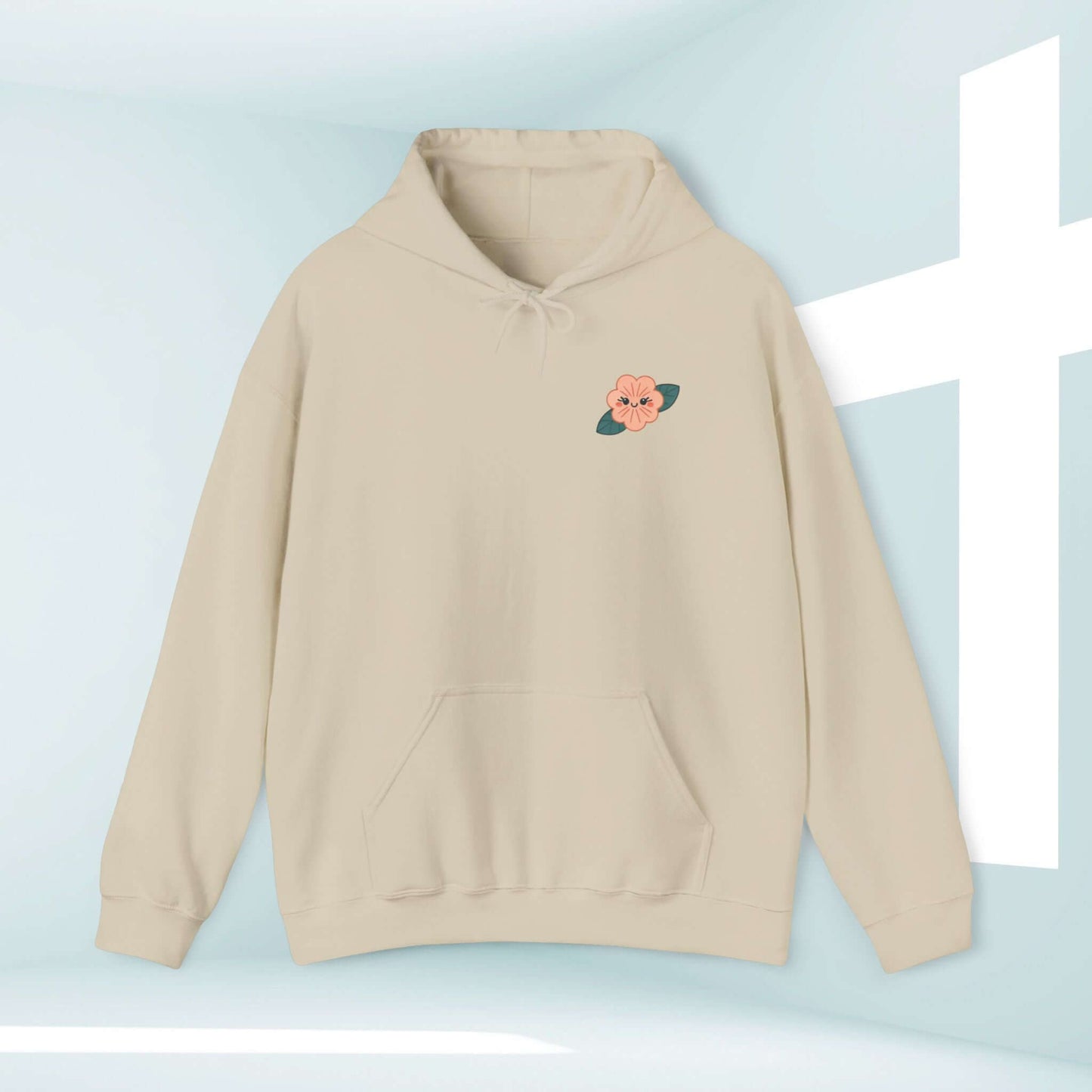 Cream Christian hoodie with floral embroidery and beachside vibes in front of a cross. Comfortable child of God Bible verse sweatshirt for all occasions.