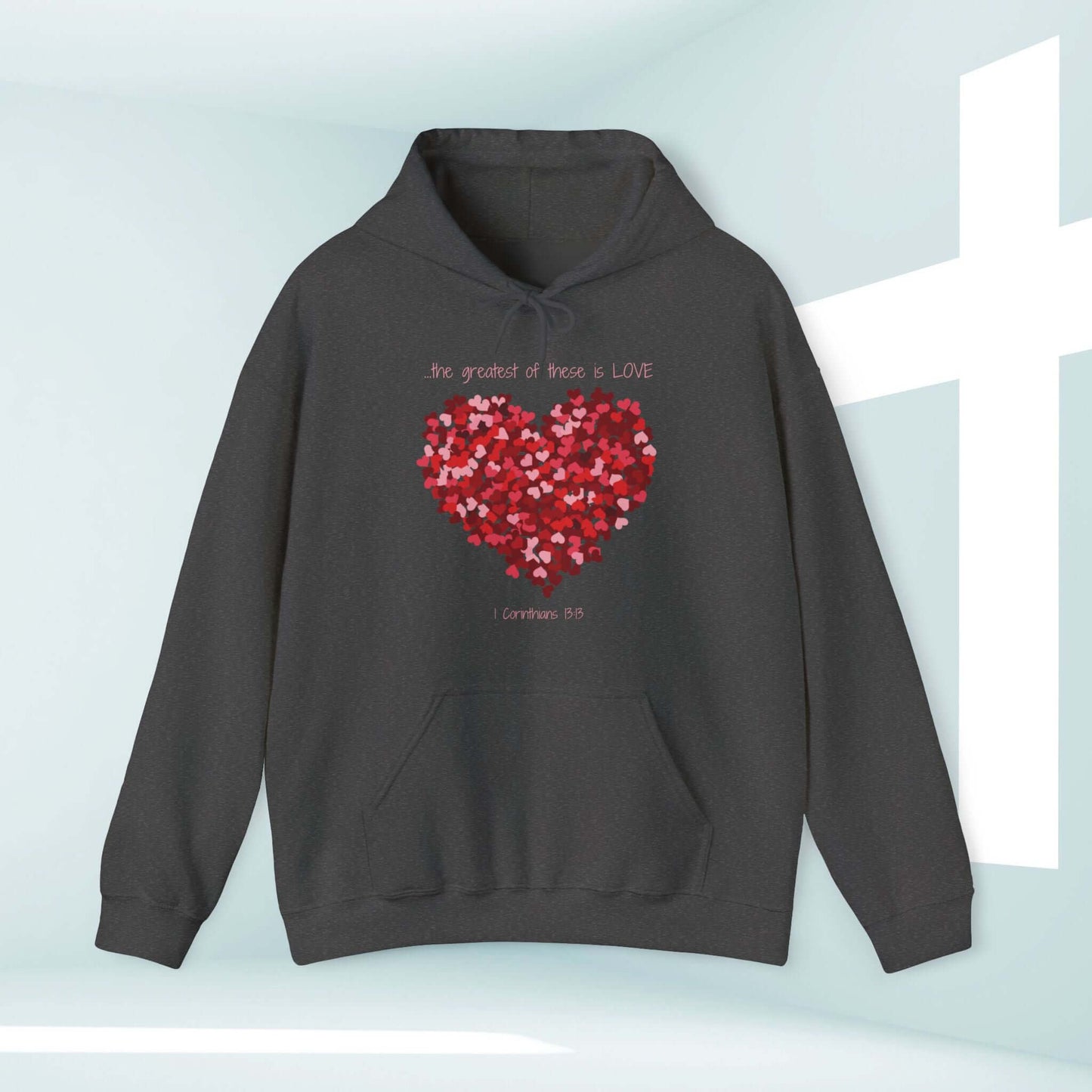 Christian Valentines Day hoodie with a heart design and Bible verse "The Greatest Of These Is Love," perfect as a valentines day gift.