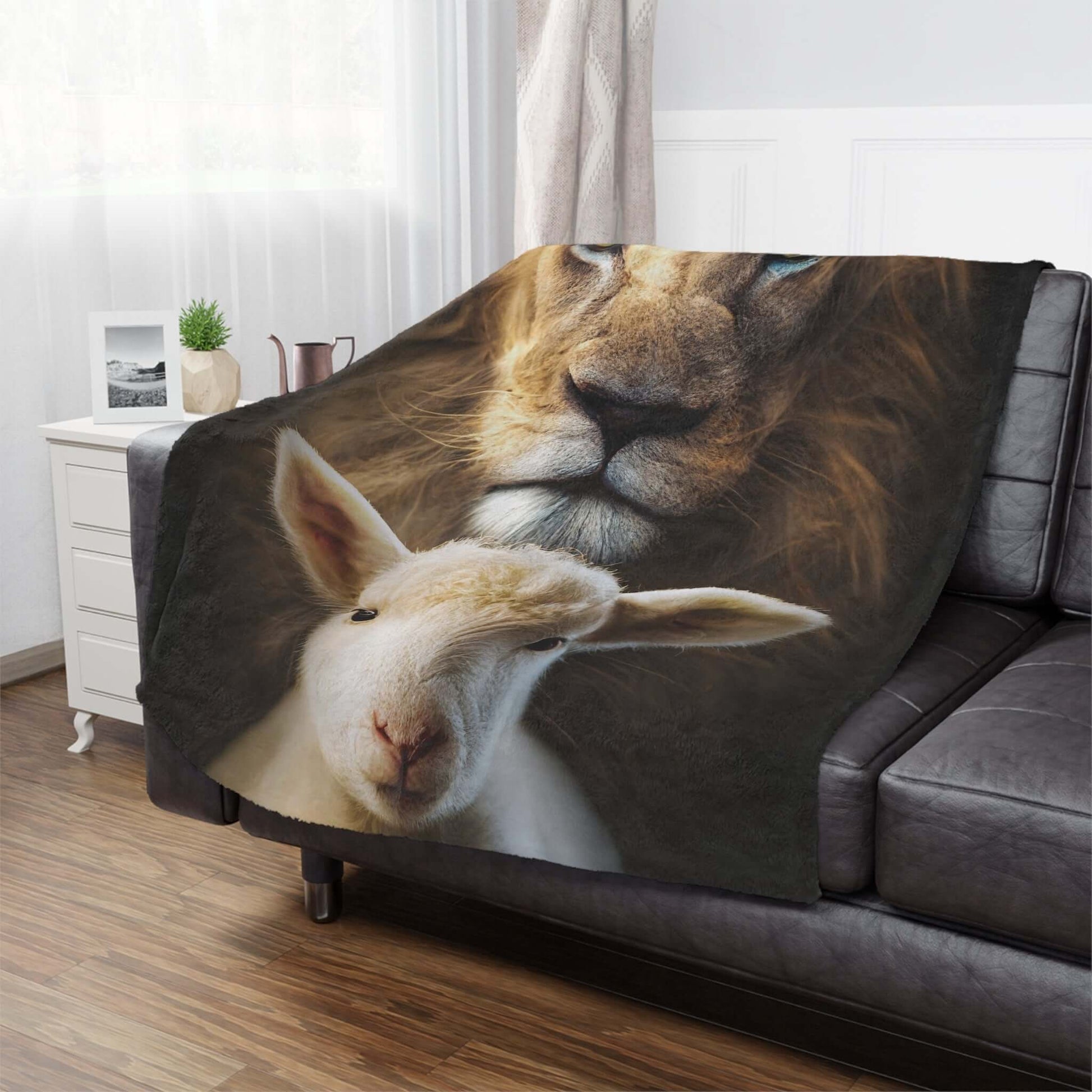 Christian Lion of Judah and Lamb of God fleece throw blanket draped over sofa, perfect religious home decor and cozy Christian bedding.