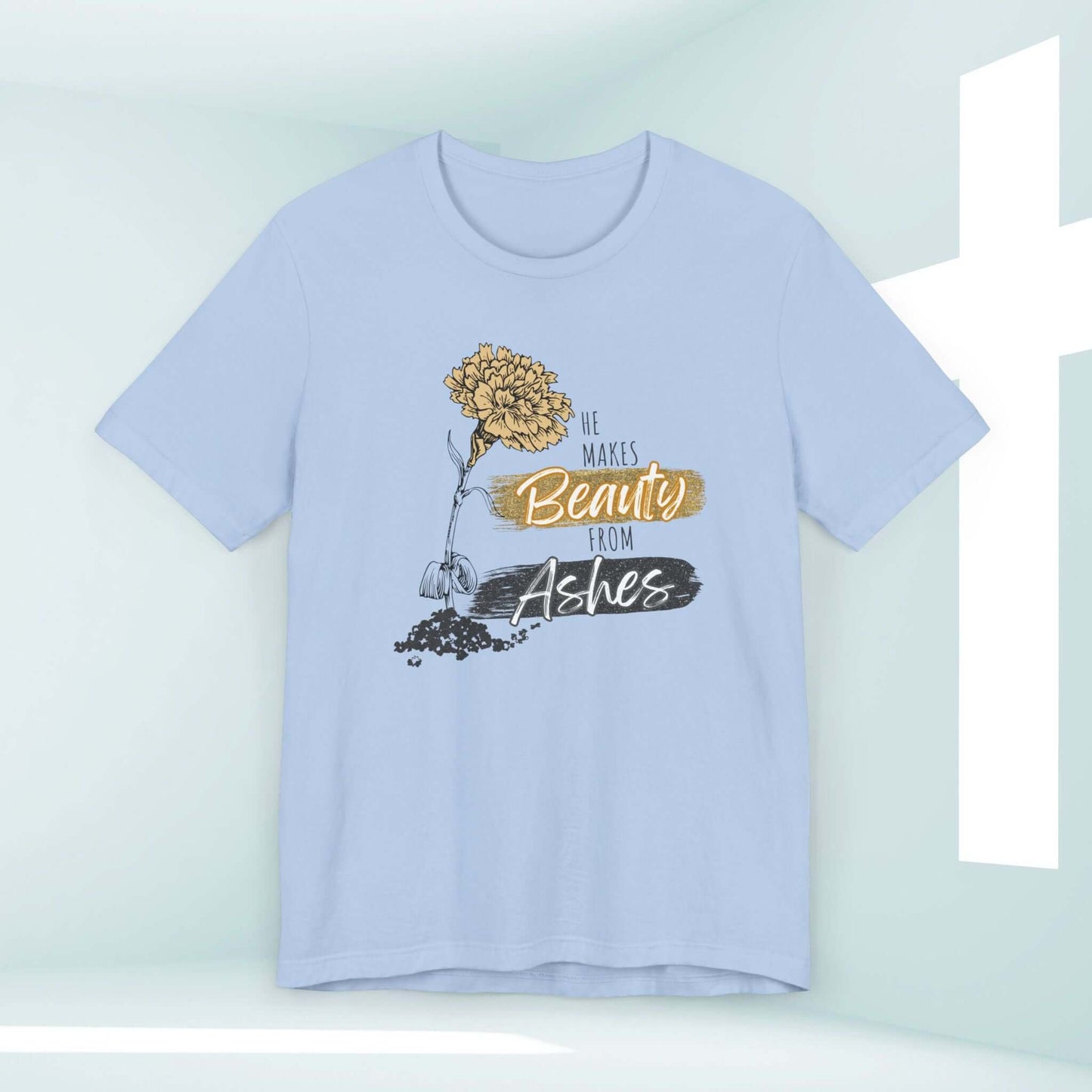 He Makes Beauty From Ashes Women's Christian T-Shirt featuring Bible verse, faith-based message on light blue tee with a flower graphic.