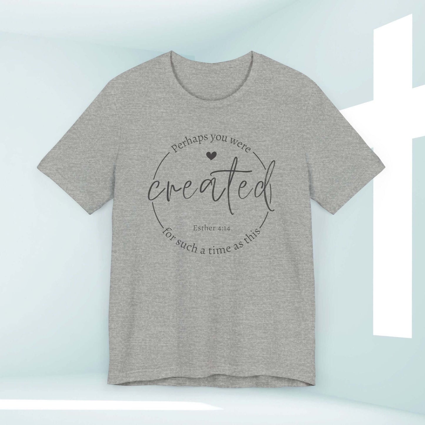 Esther 4:14 Christian t-shirt that says "Perhaps you were created for such a time as this" in a light grey color with a cross in the background.