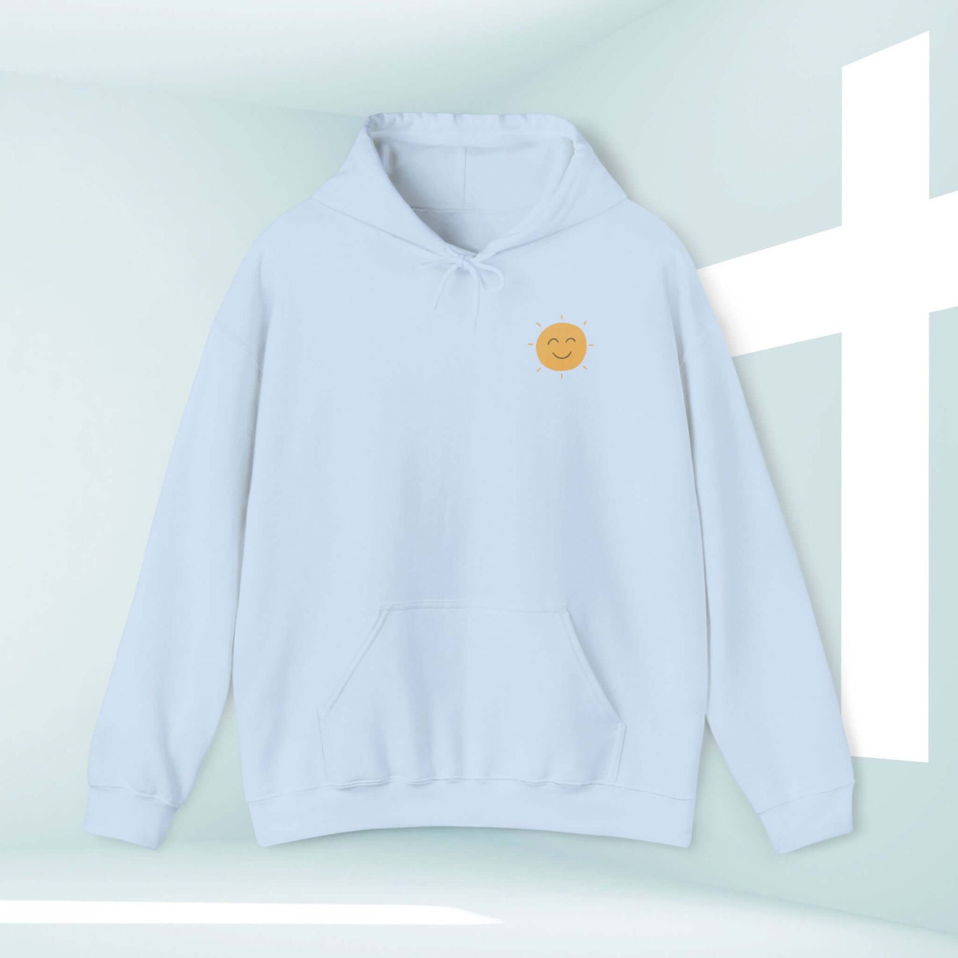 Light blue Christian hoodie with smiling sun graphic, inspired by faith and Jesus, perfect for sharing your testimony and spreading joy.