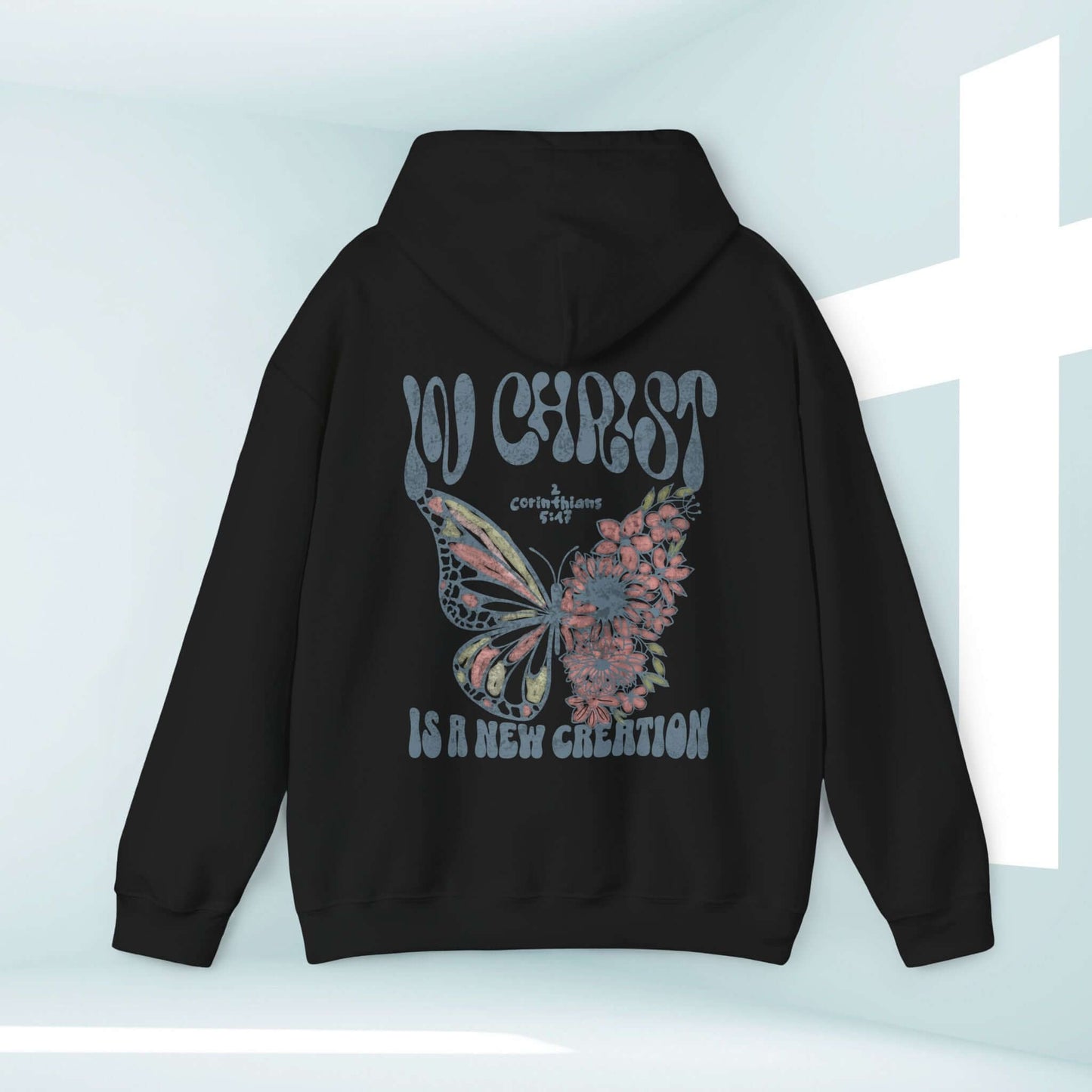 Butterfly Christian Hoodie with "In Christ Is A New Creation" Bible verse on a black hooded sweatshirt for faith-based inspiration.