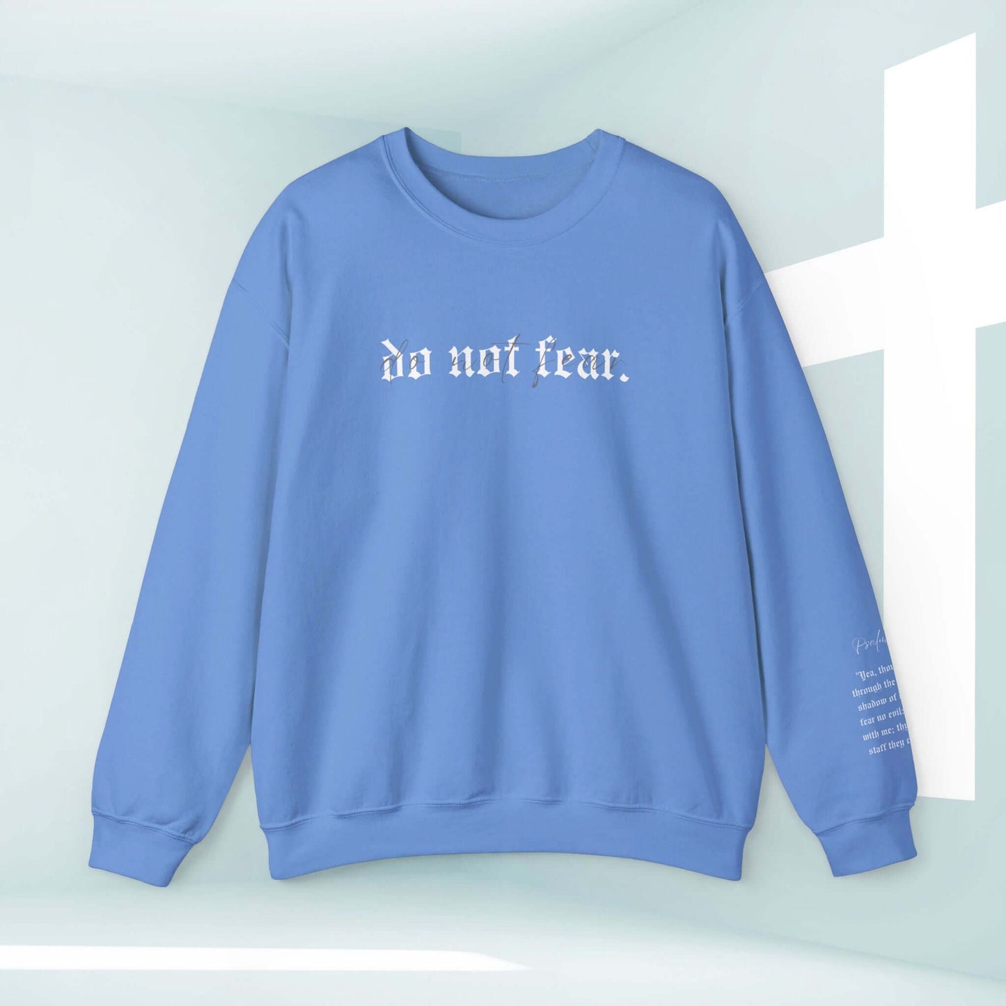 Blue Christian sweatshirt with "Do Not Fear" text, faith-based no fear shirt featuring inspiring message against a background with a white cross