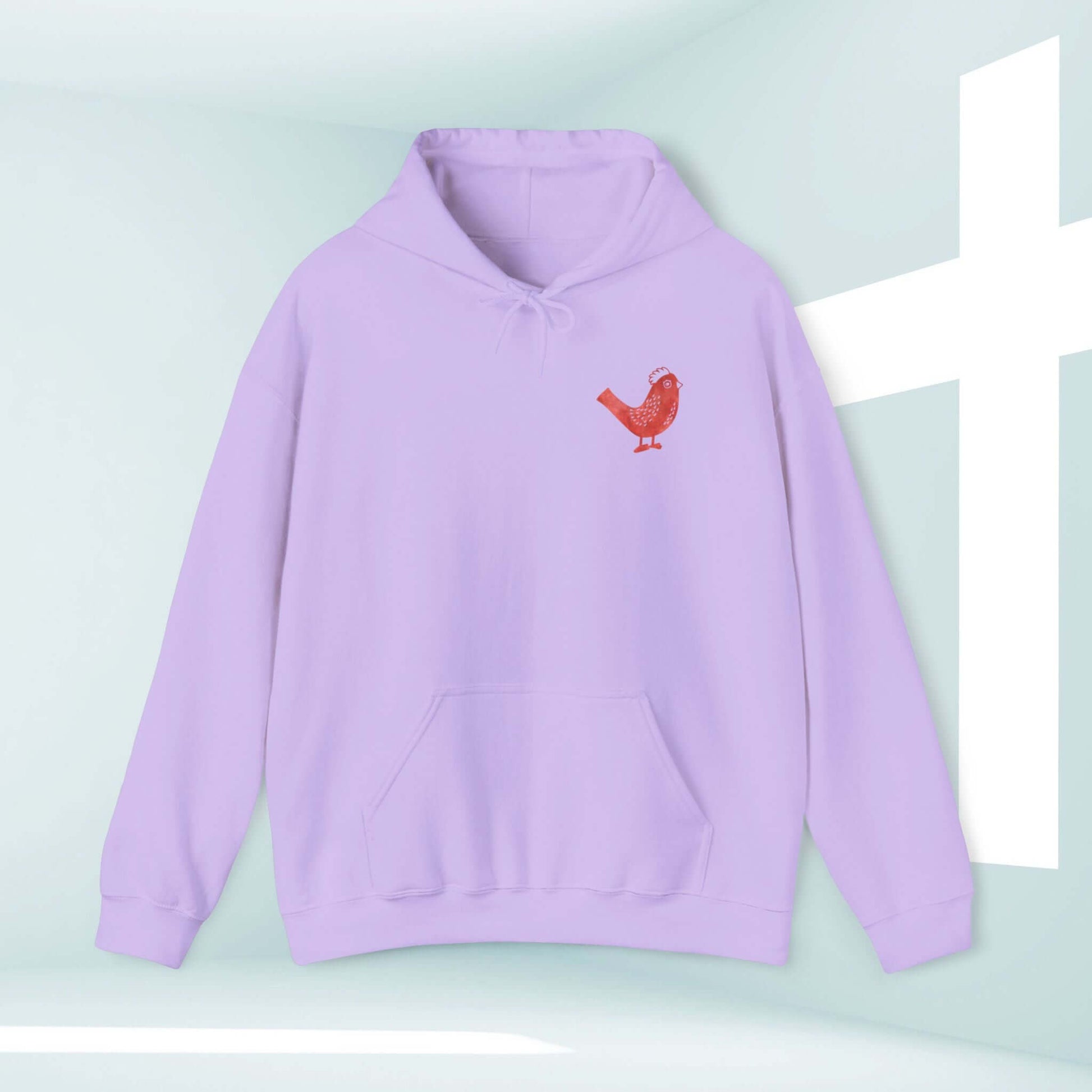 Pastel purple Kingdom Bound faith-based Christian hoodie with bird graphic next to a white cross backdrop. Ideal for Christian concerts.