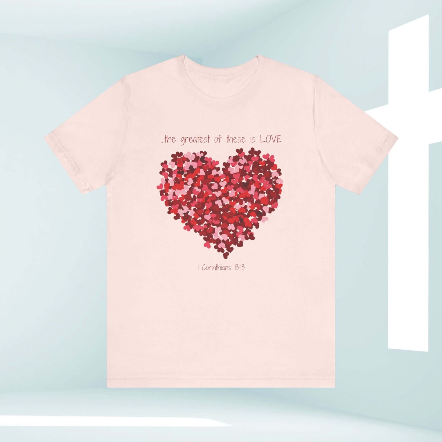 Christian Valentine's Day T-shirt with a heart graphic and "The greatest of these is love" text, perfect for weddings or anniversaries.