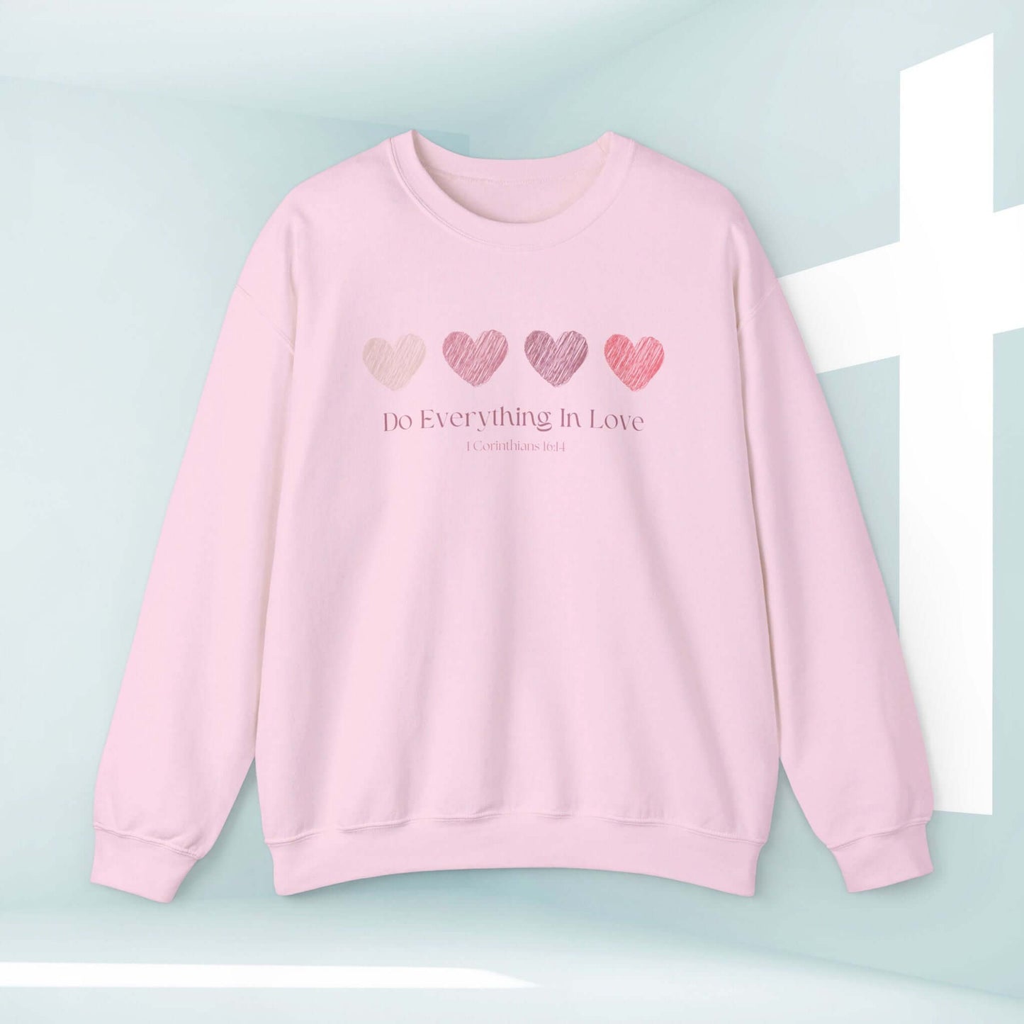 Pink Valentine's Day sweatshirt with faith-based heart graphics and message "Do Everything In Love," perfect for wedding, anniversary, or engagement gift.