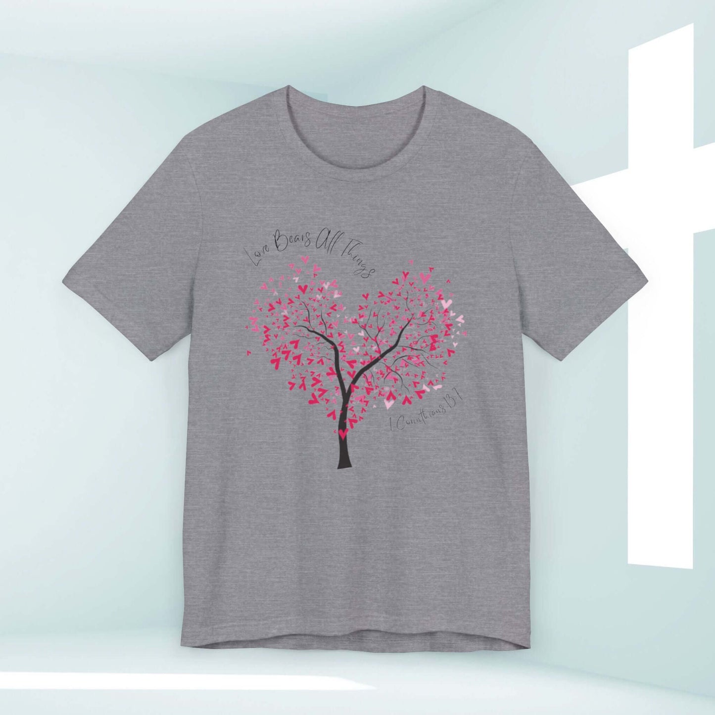 Gray Christian love t-shirt with heart tree graphic 'Love Bears All Things' text, ideal for wedding, valentines, or faith-based gifts.