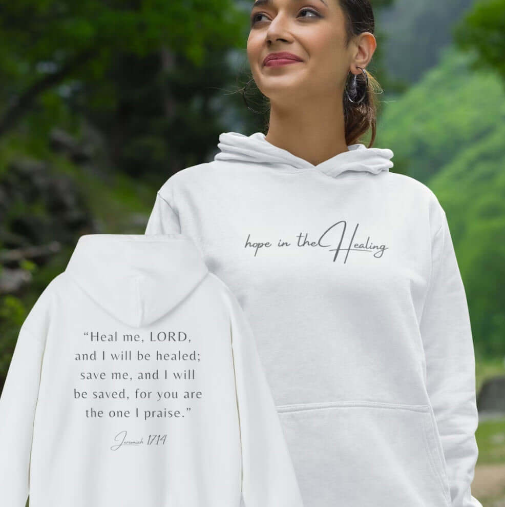 Woman wearing Hope In The Healing Christian hoodie with biblical verse, ideal get well soon or hospital gift, inspirational faith-based sweatshirt