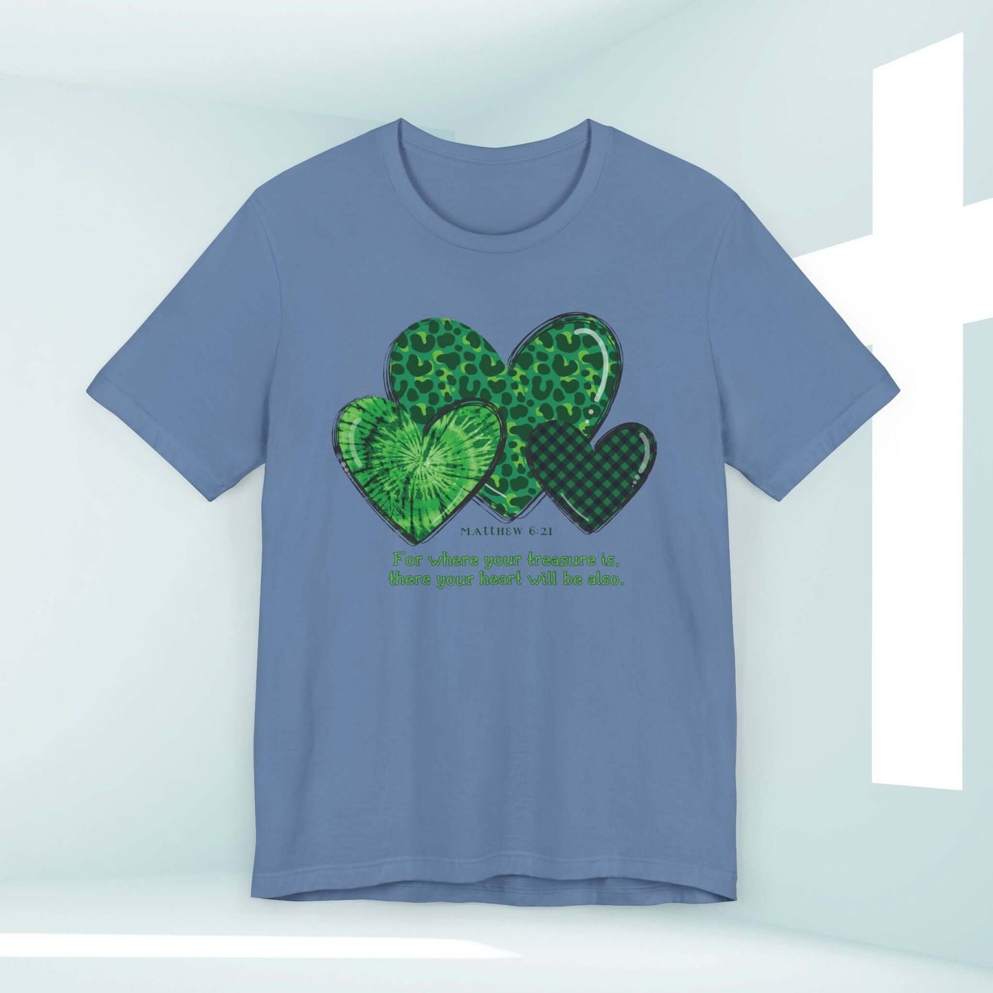 St Patrick's Day Christian tee with shamrock hearts and Bible verse in green on blue background. Irish-themed religious t-shirt.