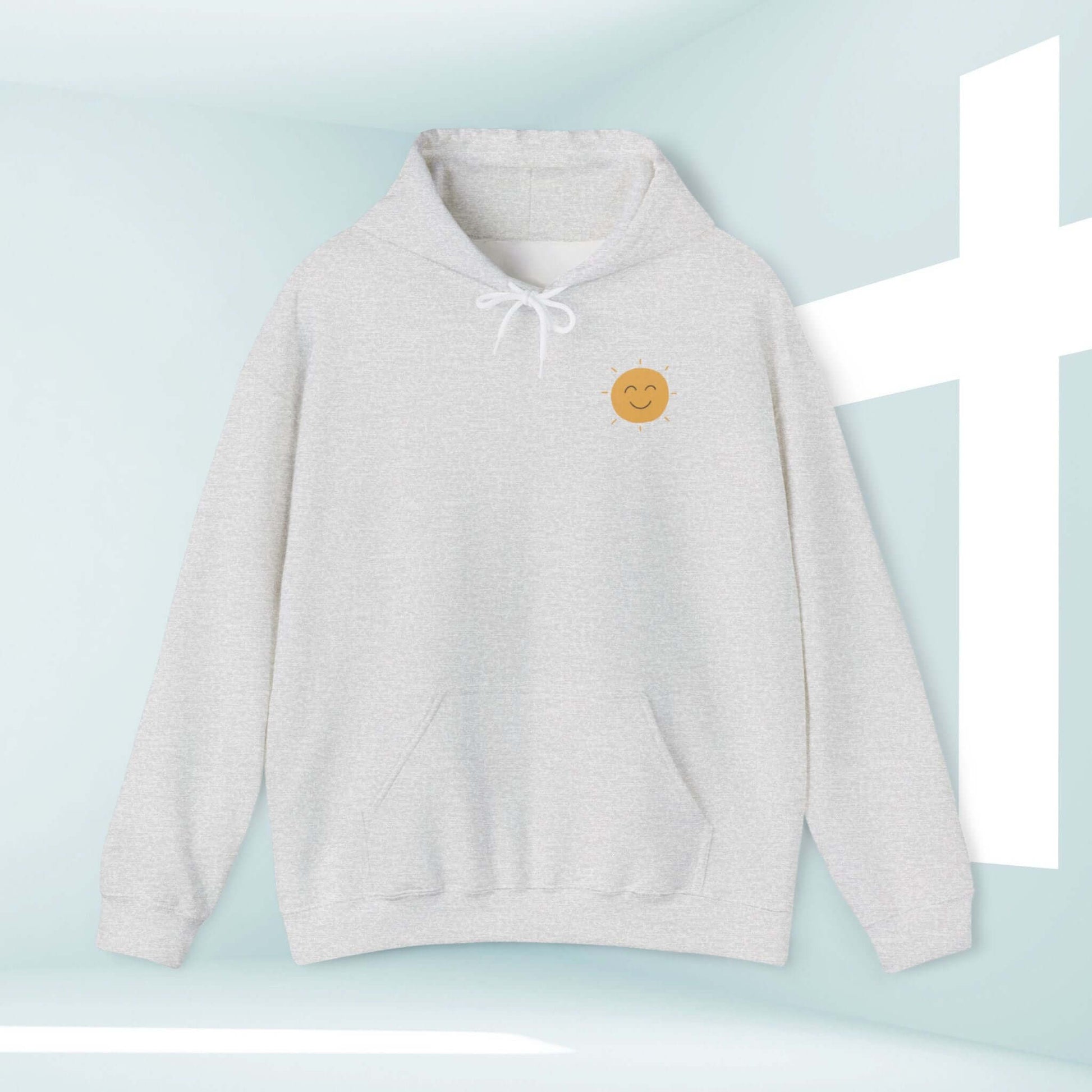 Christian boho hoodie with smiley face in front of a cross, inspirational faith-based hooded sweatshirt for believers.