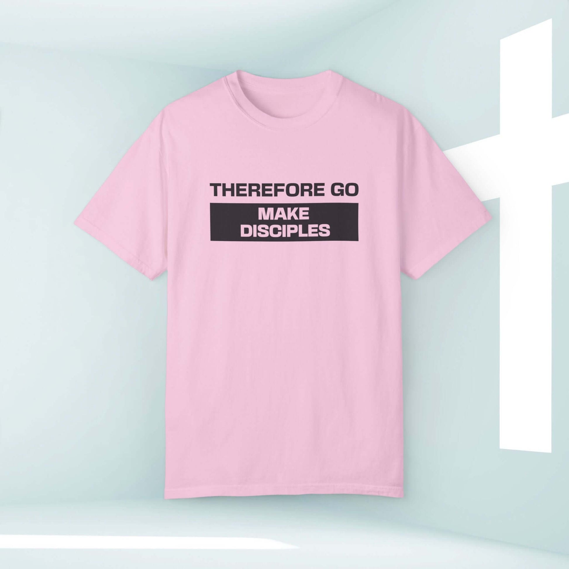 Pink Christian tee with "Therefore Go Make Disciples" text promoting elevated faith and inspirational worshipwear