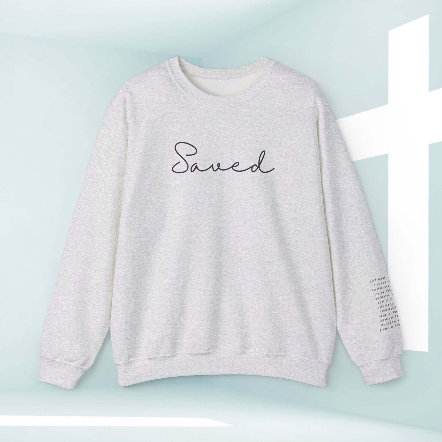 Christian sweatshirt Saved Sinners Prayer, inspirational religious apparel, crewneck faith sweatshirt with “Saved” text and prayer on sleeve.