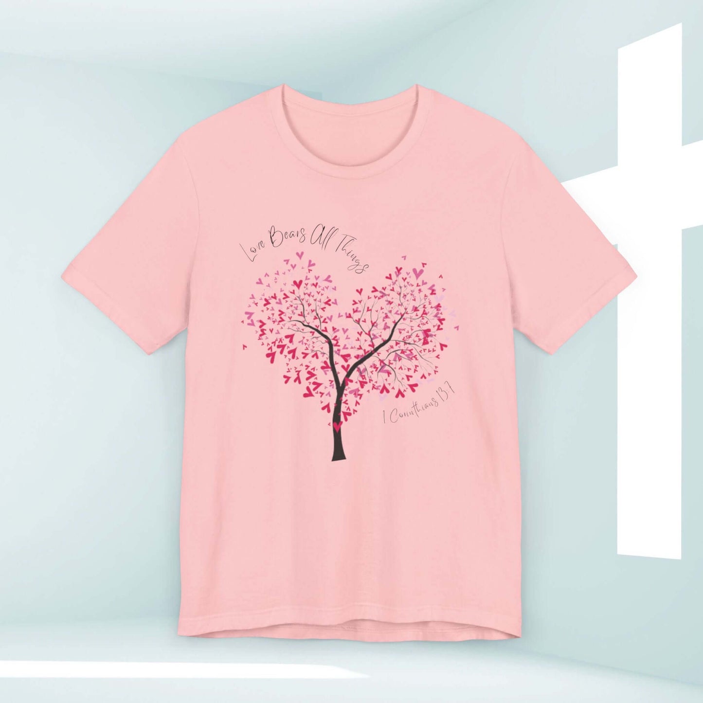 Christian Love Bears All Things pink t-shirt with heart-shaped tree graphic, perfect for weddings, Valentine's Day, and faith-based occasions.