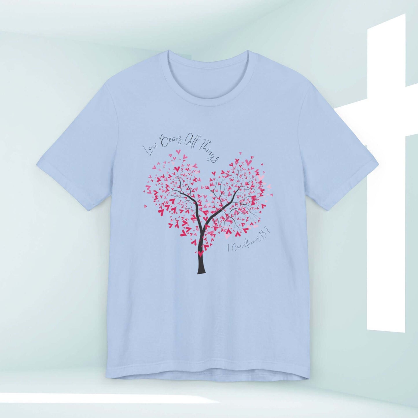 Light blue Christian love t-shirt featuring a heart-shaped tree with red leaves and "Love Bears All Things" text, perfect for weddings and Valentine's Day.