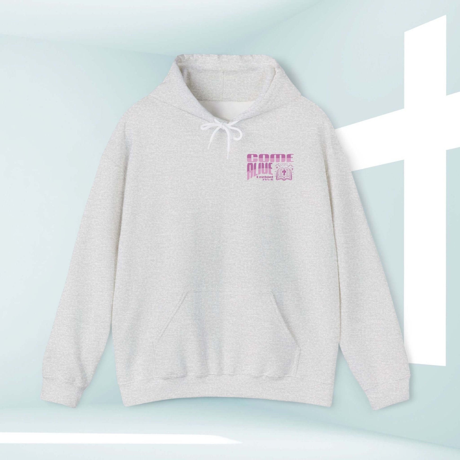 Christian hoodie with Come Alive design, featuring a Bible verse in purple text on grey hoodie, displayed with cross background