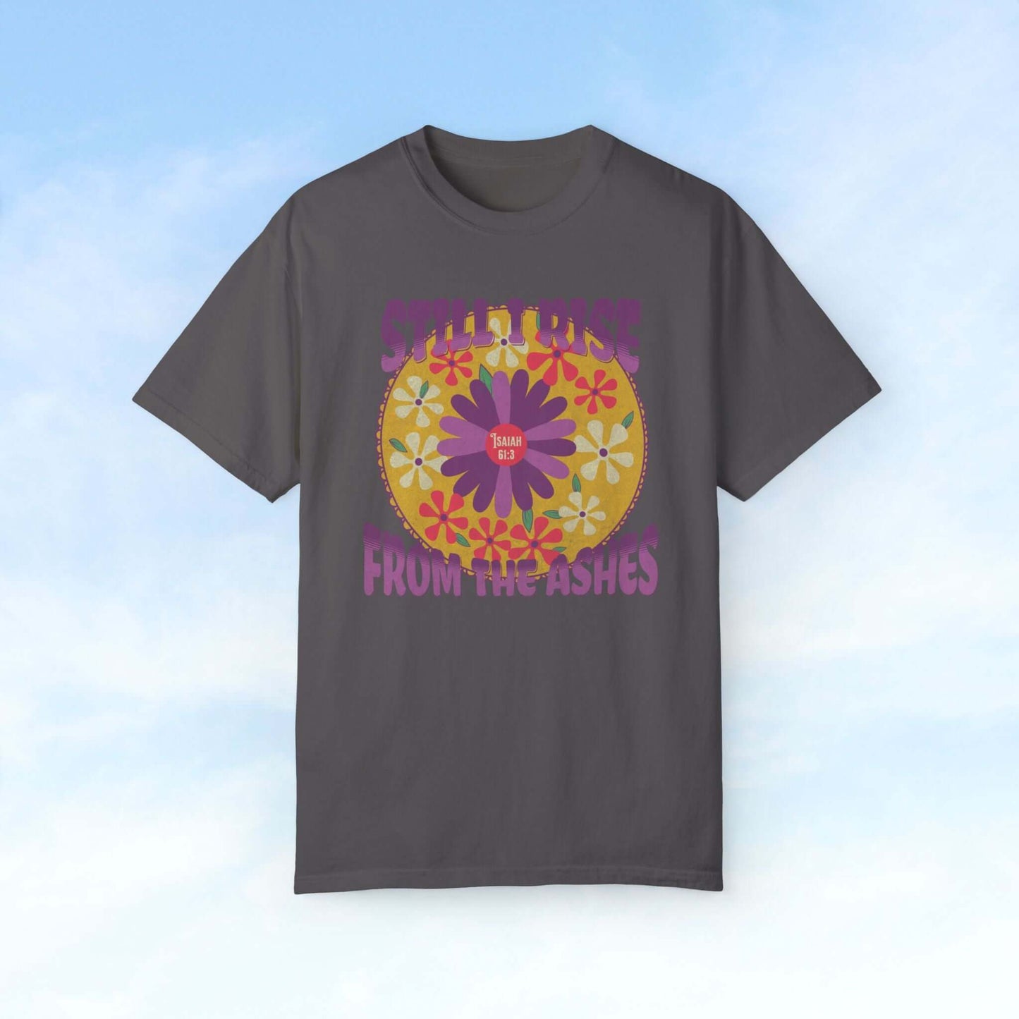 "Still I Rise From The Ashes floral Christian t-shirt with vibrant boho flowers on a gray tee against a light sky background"