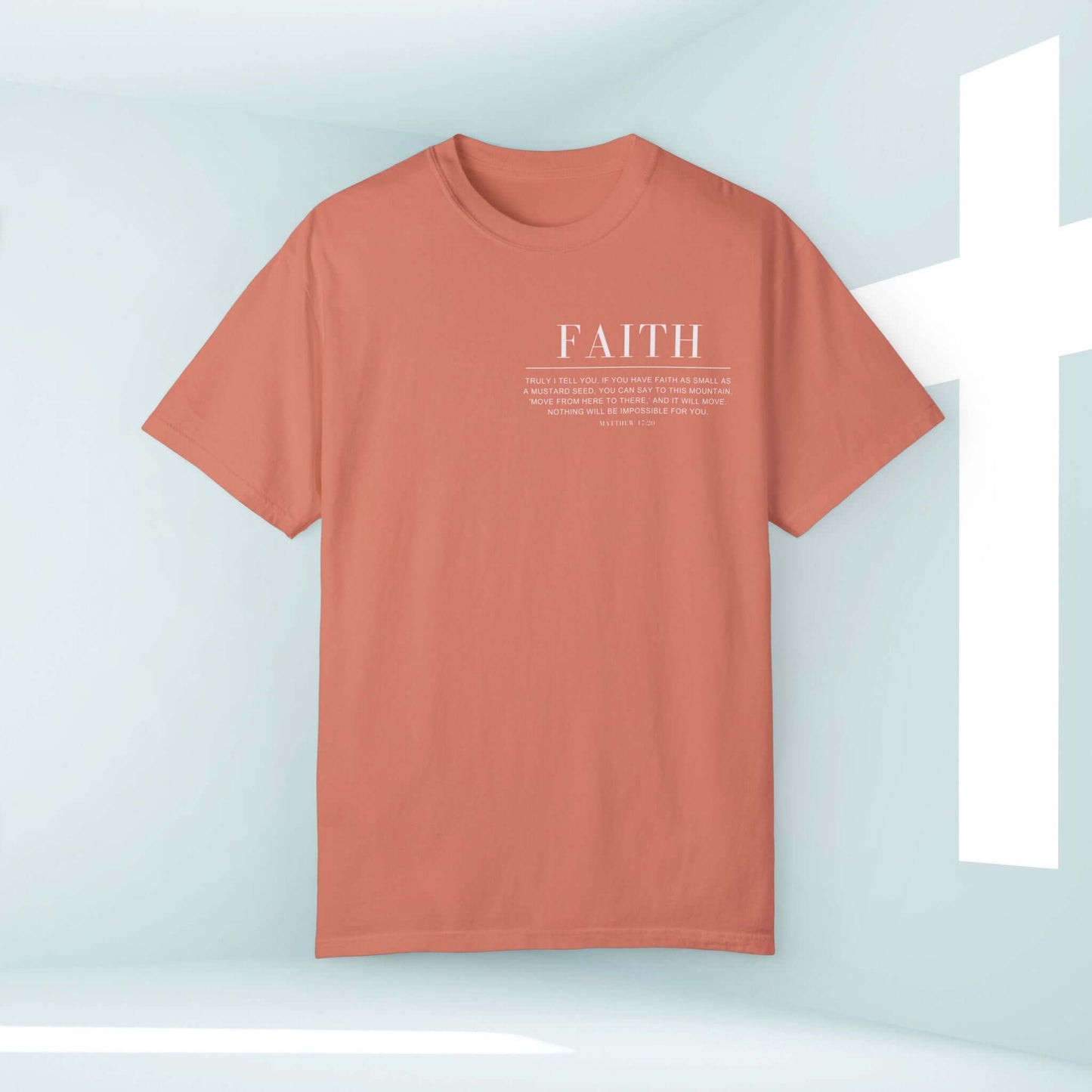 Faith Can Move Mountains Christian Shirt with Bible Verse Inspirational Tee in Coral Style in front of a cross background