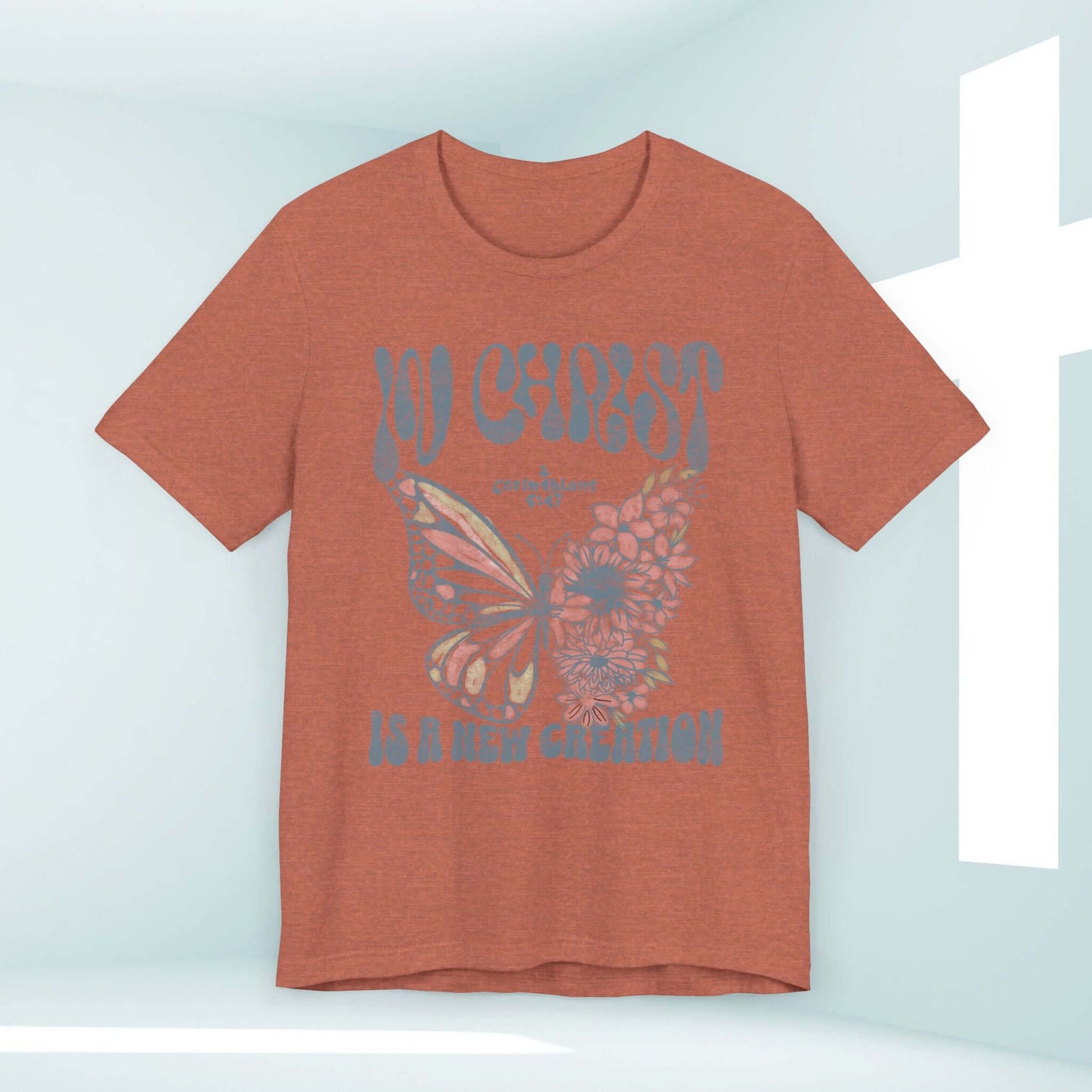 In Christ Is A New Creation Butterfly Christian shirt with Bible verse, soft airlume cotton tee, perfect Jesus apparel in rust color.