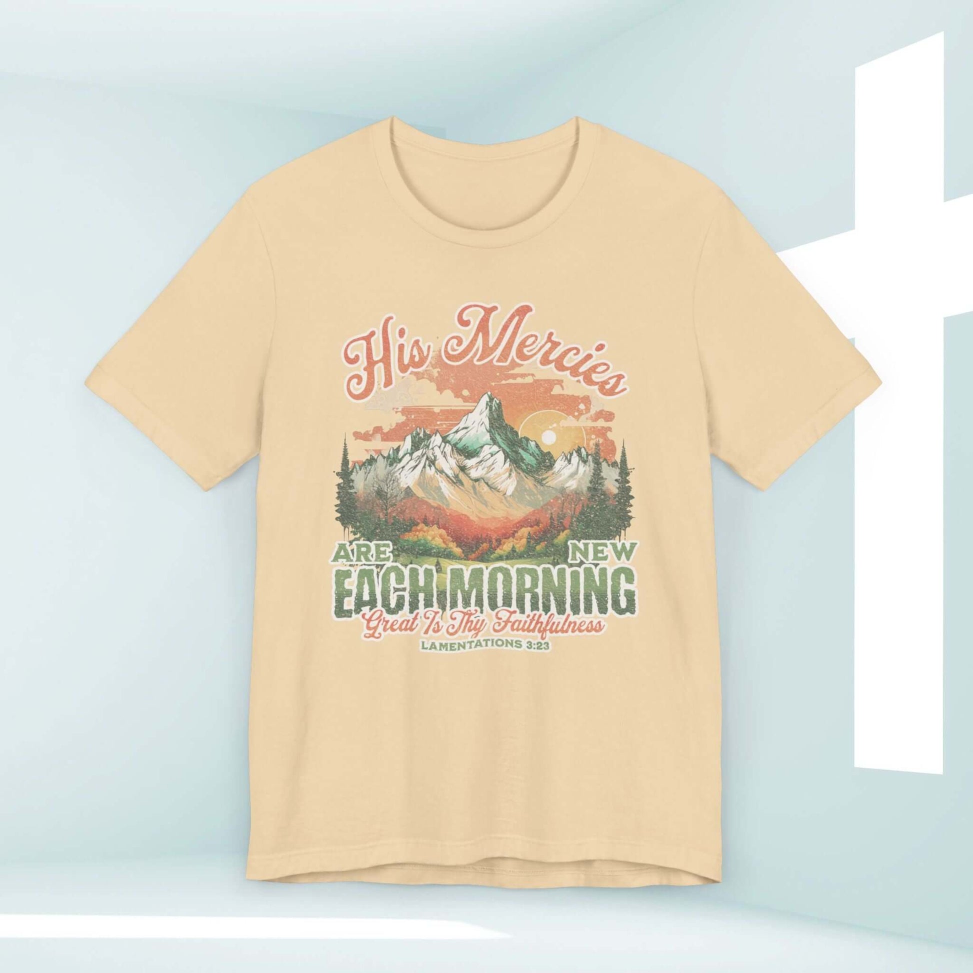 His Mercies Are New Each Morning Christian t-shirt with Bible verse; beige color with scenic mountain design.