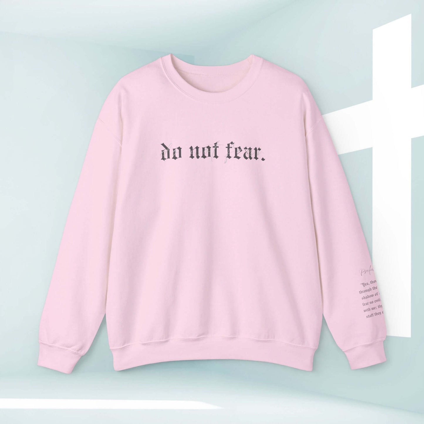 Pink Christian sweatshirt with "Do Not Fear" inspirational bible verse, faith-based apparel featuring a positive message.