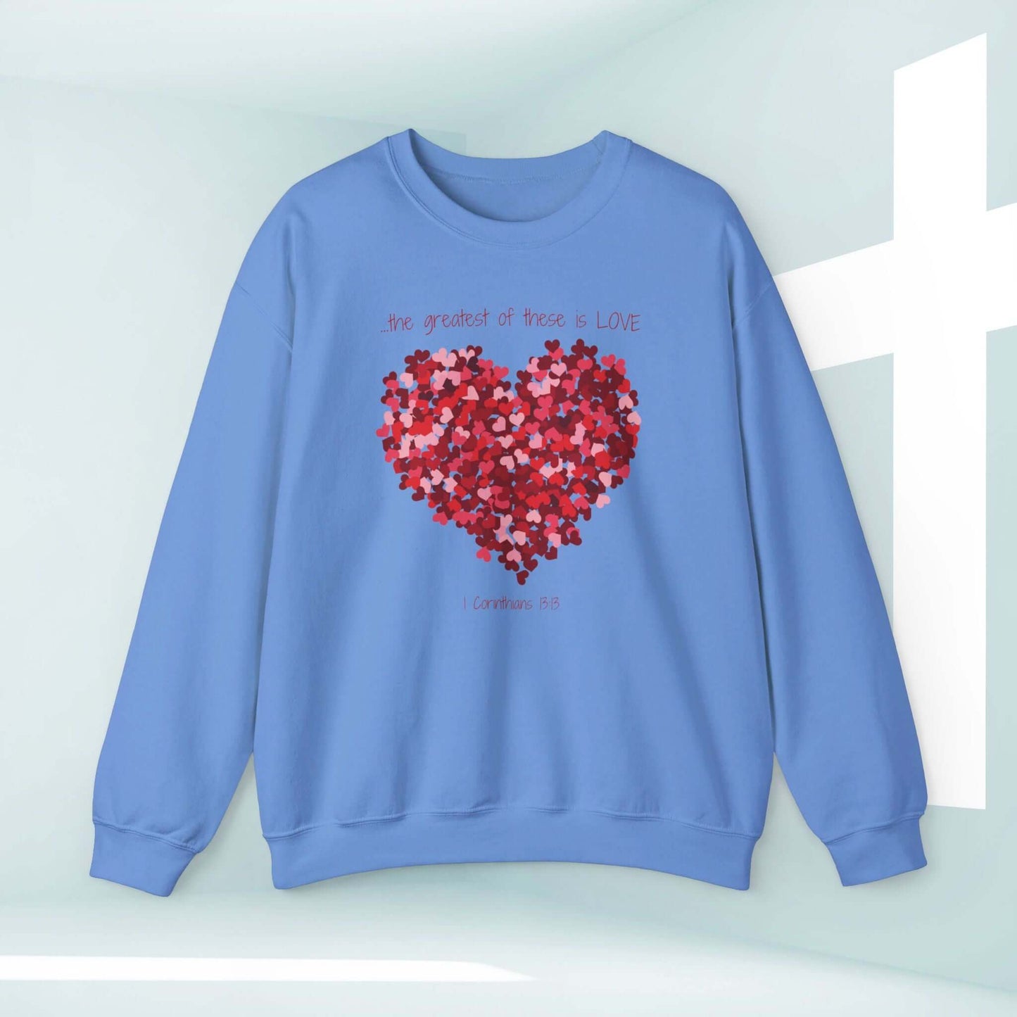 Blue Christian valentines sweatshirt with heart design and Bible verse "The greatest of these is LOVE" from 1 Corinthians 13.