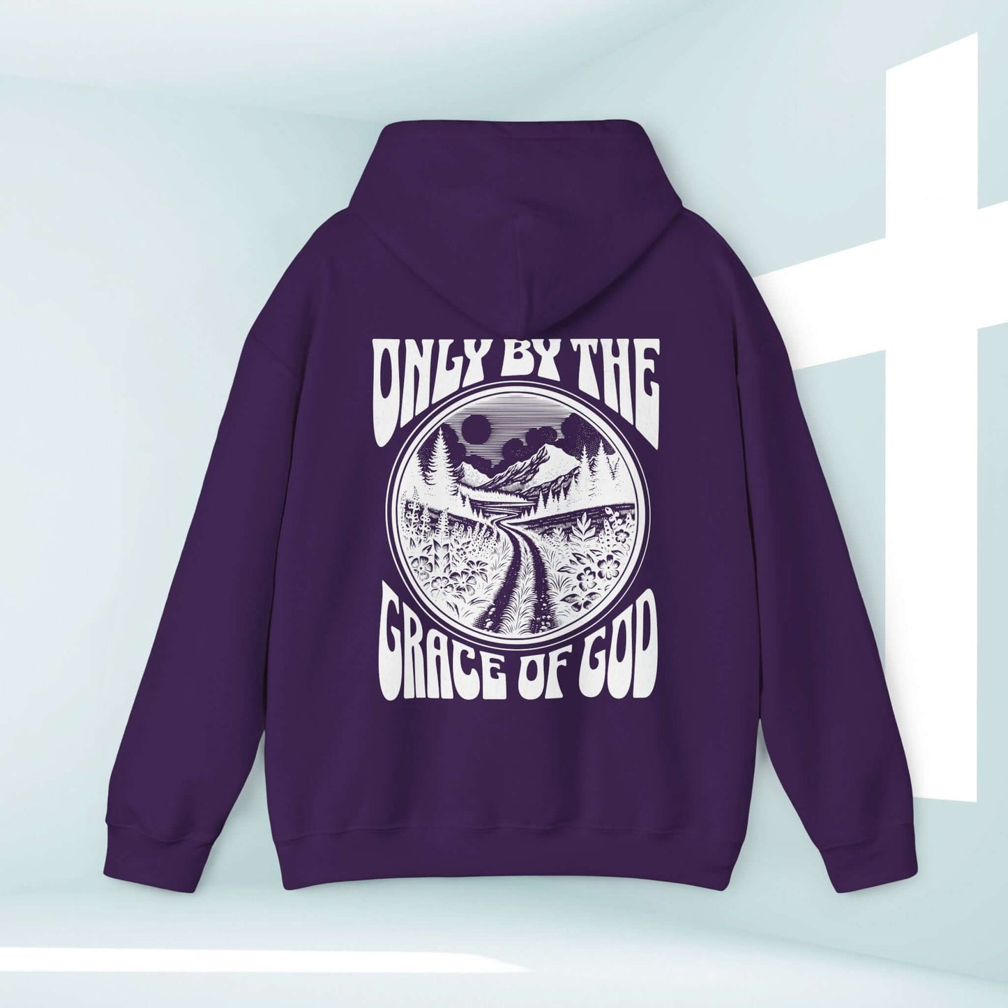 Christian hoodie with "Only By The Grace Of God" Bible verse design displayed in a serene mountain landscape background.