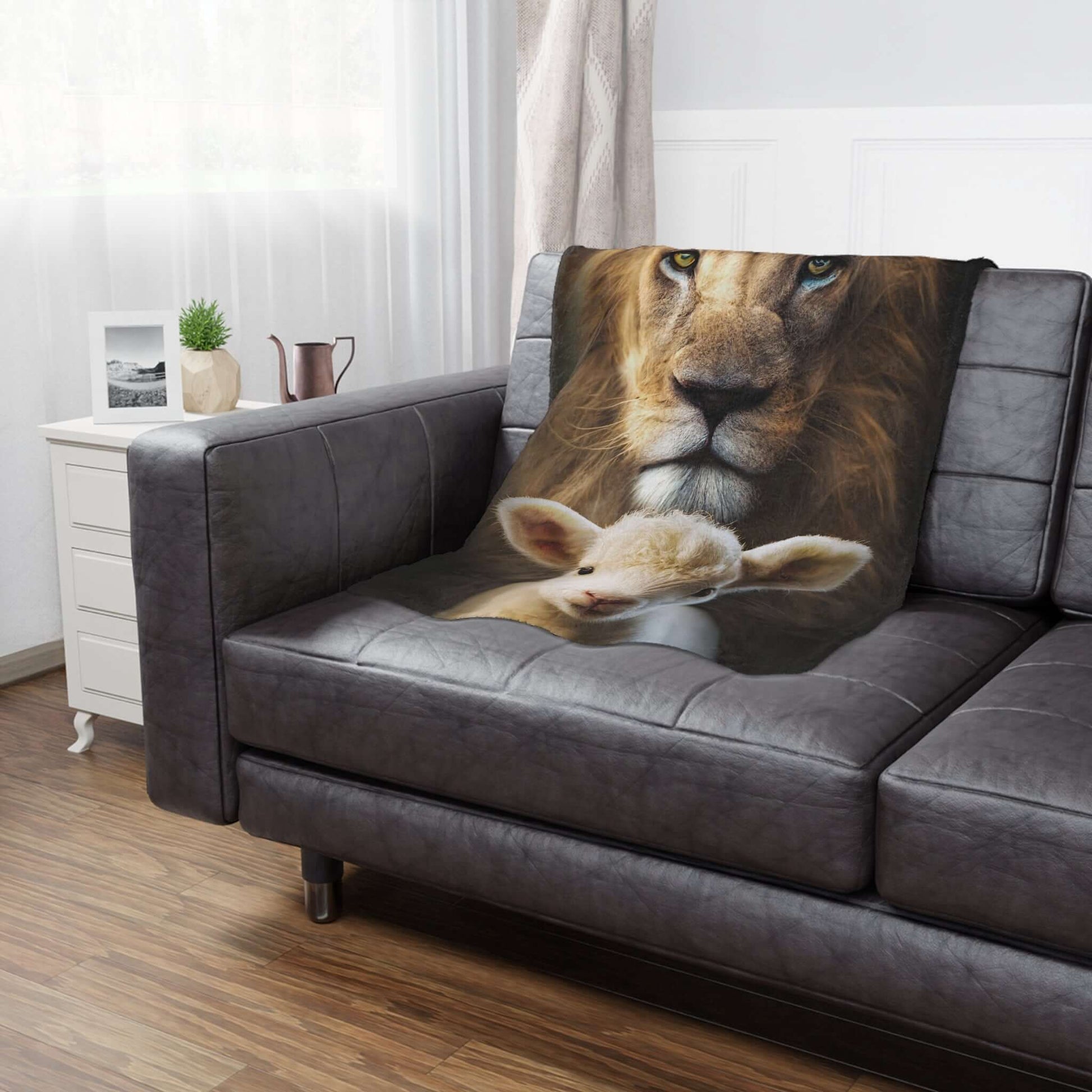 Christian blanket with Lion of Judah and Lamb of God design on a black sofa, perfect for religious home decor or a cozy Christian gift.