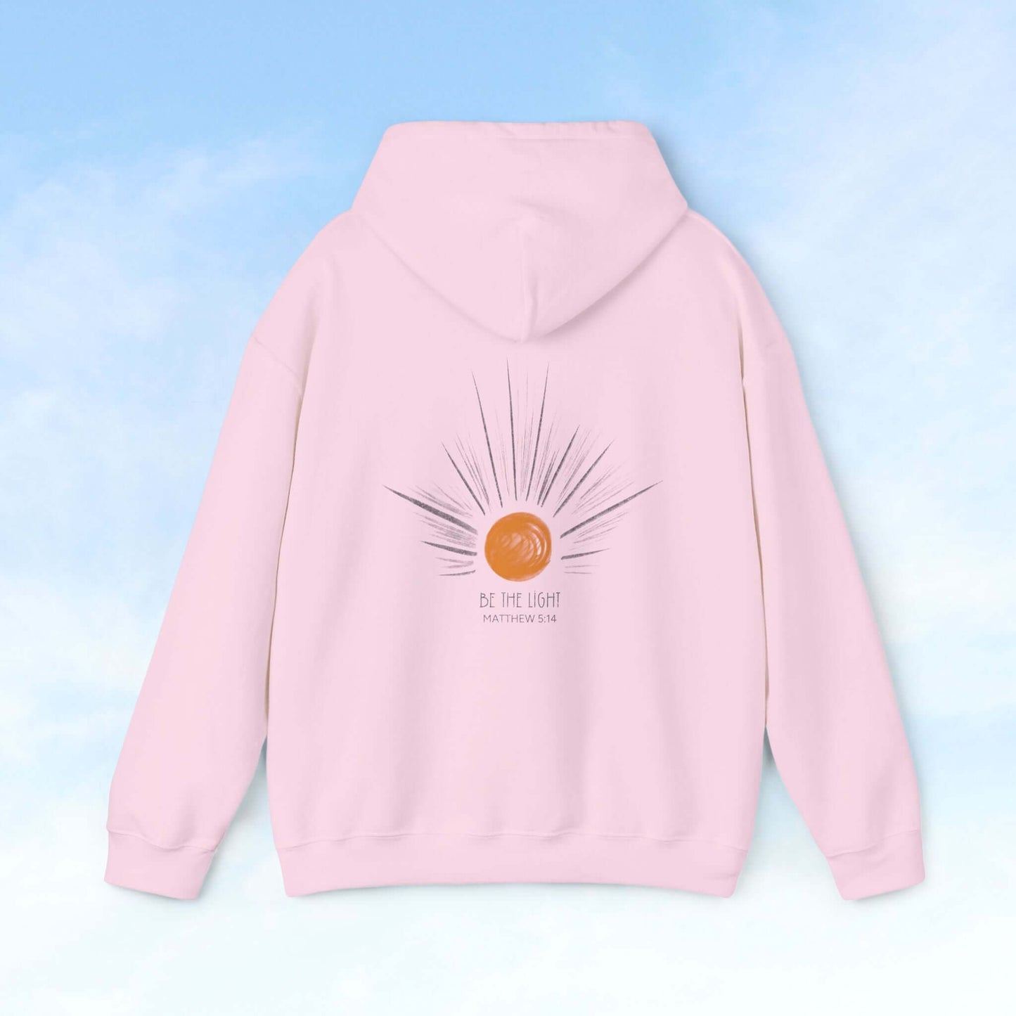 Be The Light sunburst Christian hoodie with celestial sun and rays on a soft pink background, perfect gift for wife or mother.